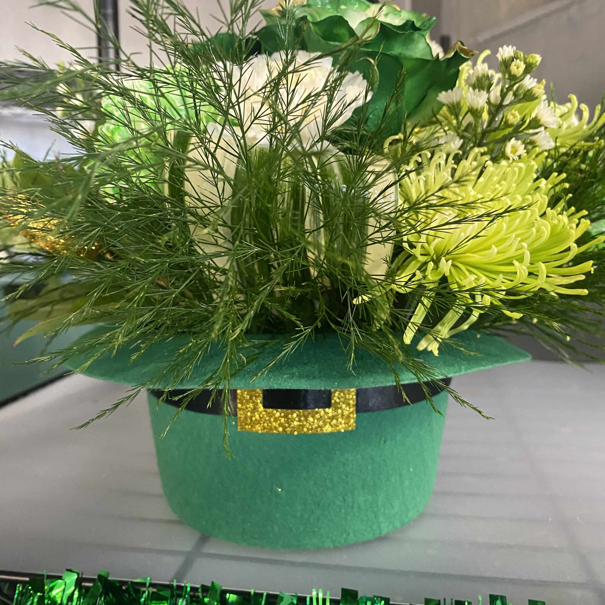 Green floral arrangement in a leprechaun hat container