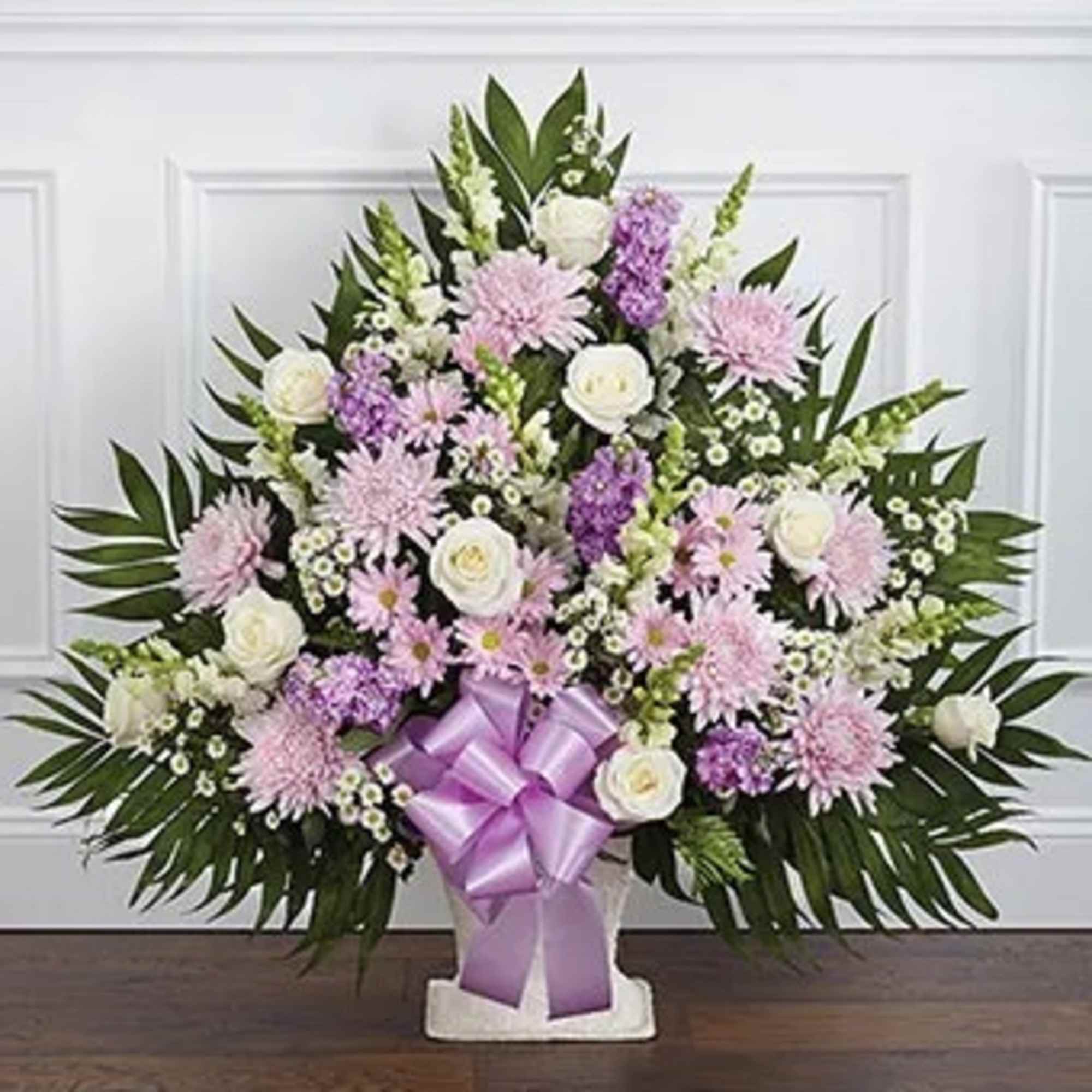 Lavender and white floral spray with a purple ribbon bow