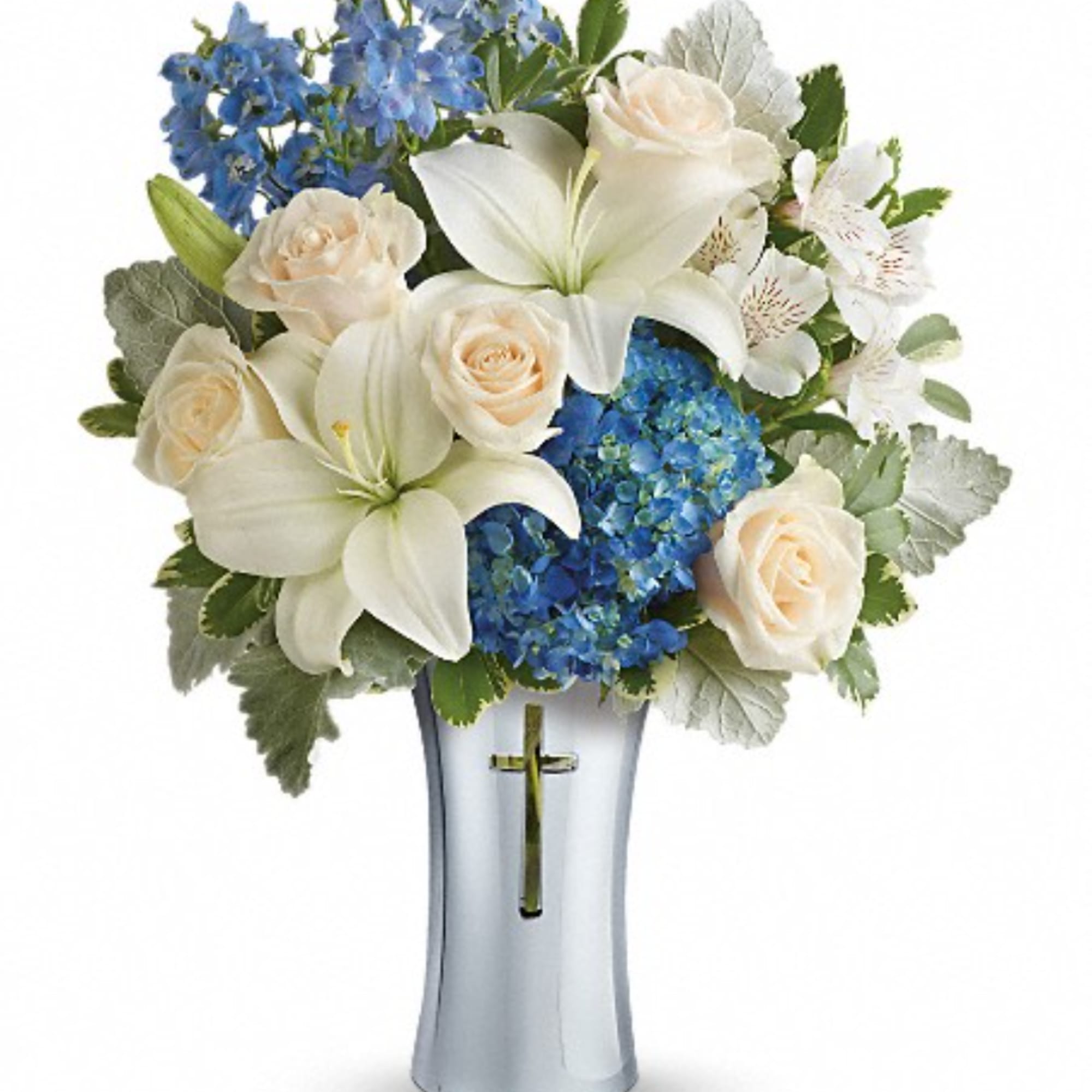 White lilies and cream roses in a silver vase with blue flowers