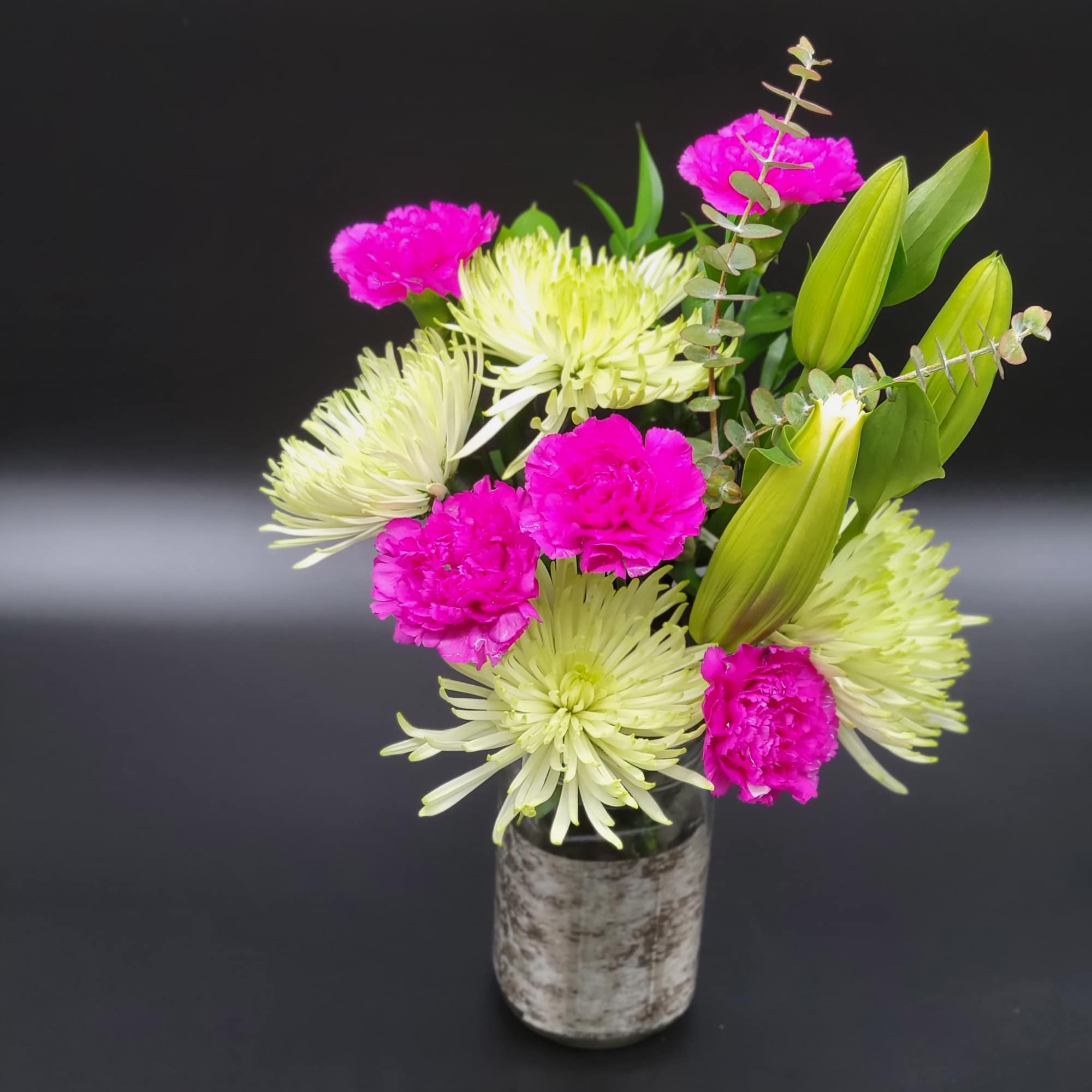 Pink carnations and pale green spider mums in a small vase, photo 2 of 2