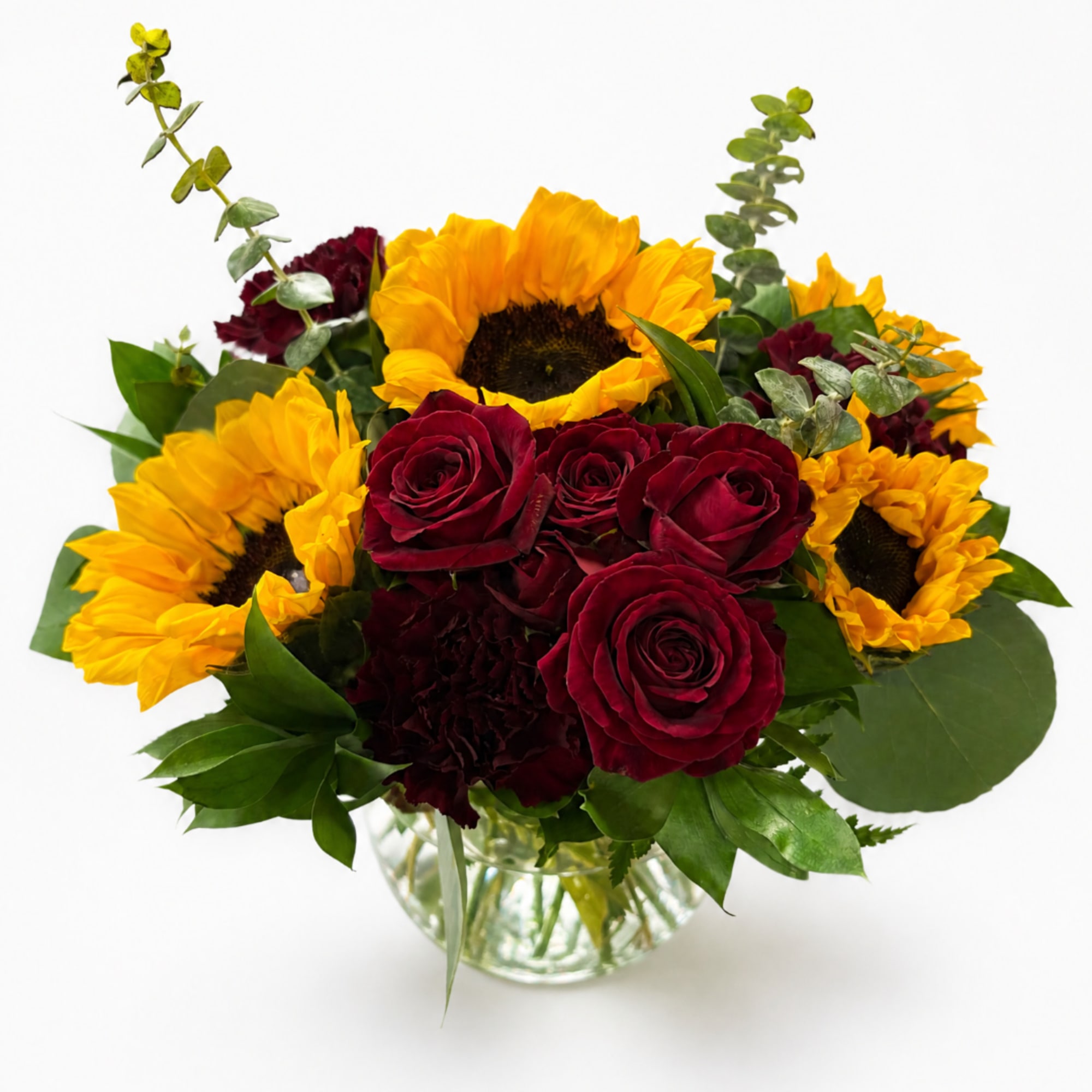 Bouquet of red roses and yellow sunflowers in a glass vase