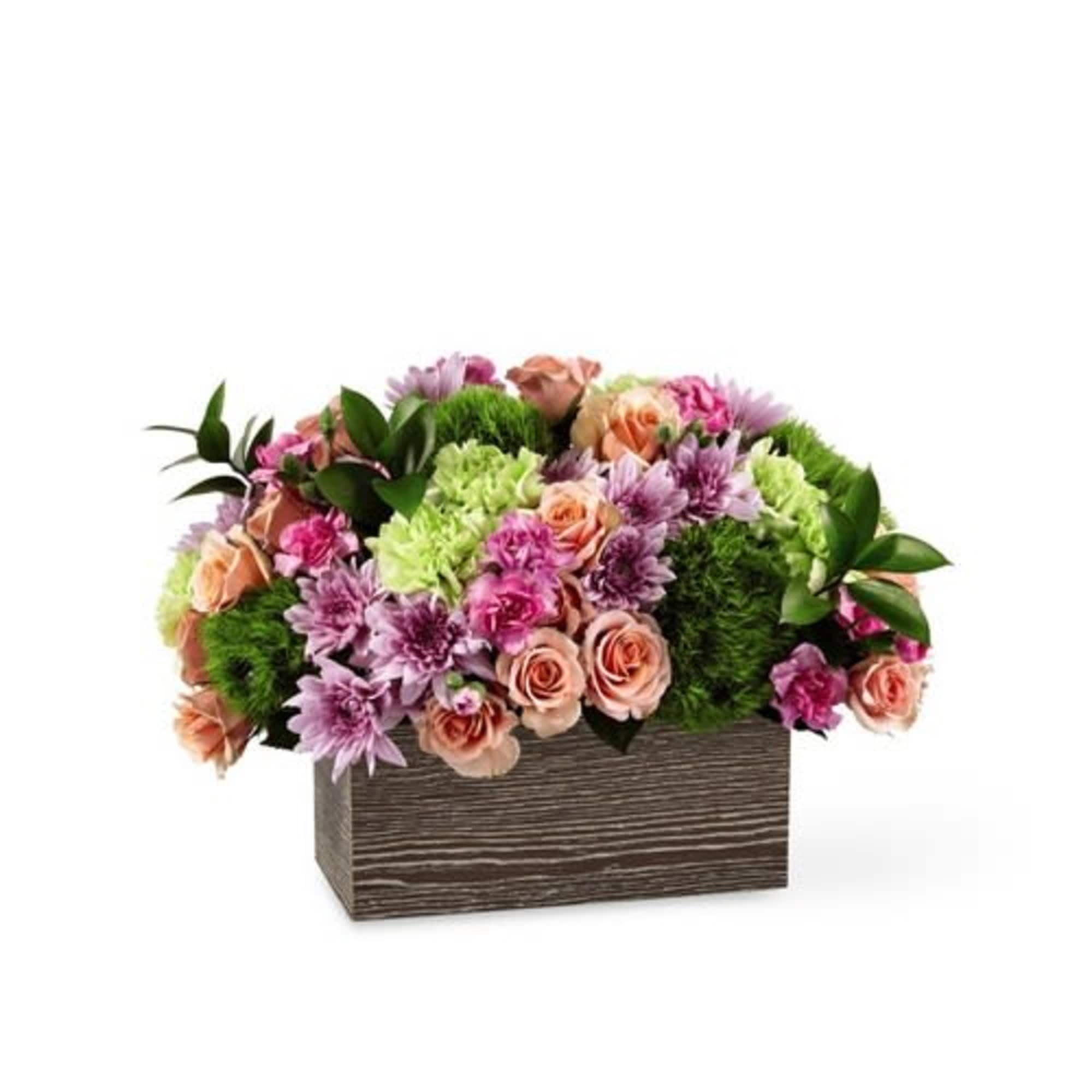 Mixed pink and peach flowers in a rectangular wooden box