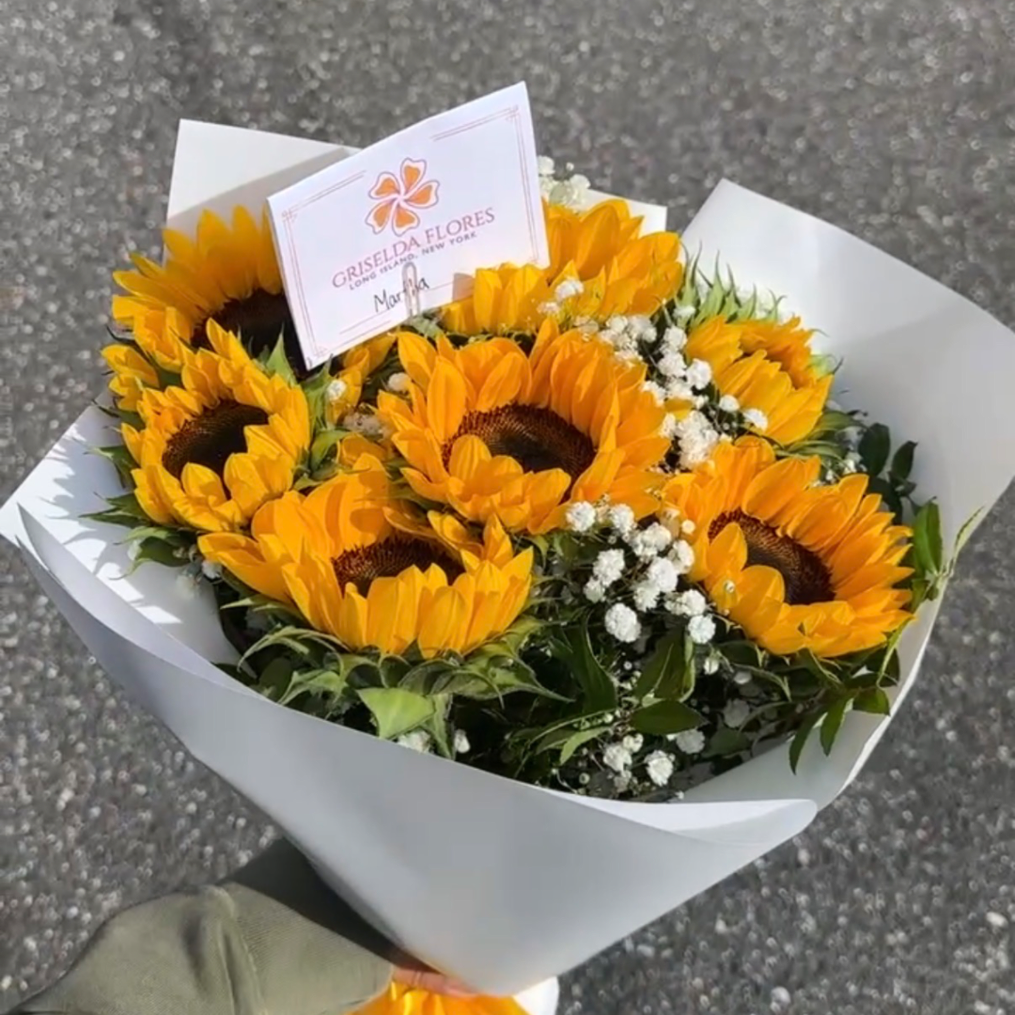 Bouquet of sunflowers wrapped in white paper