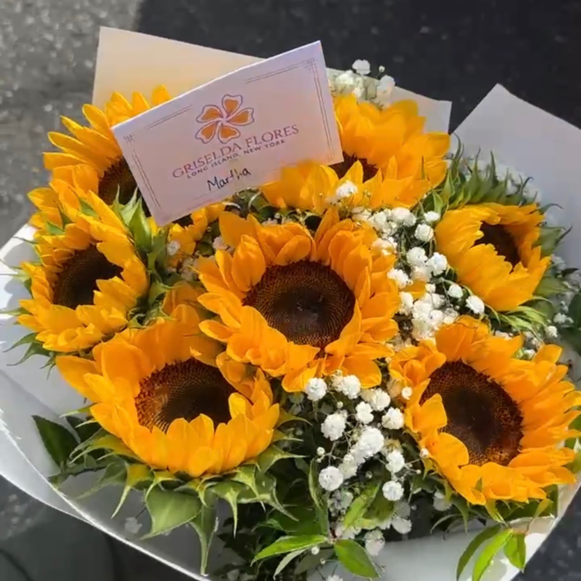 Bouquet of sunflowers with baby's breath and white wrapping