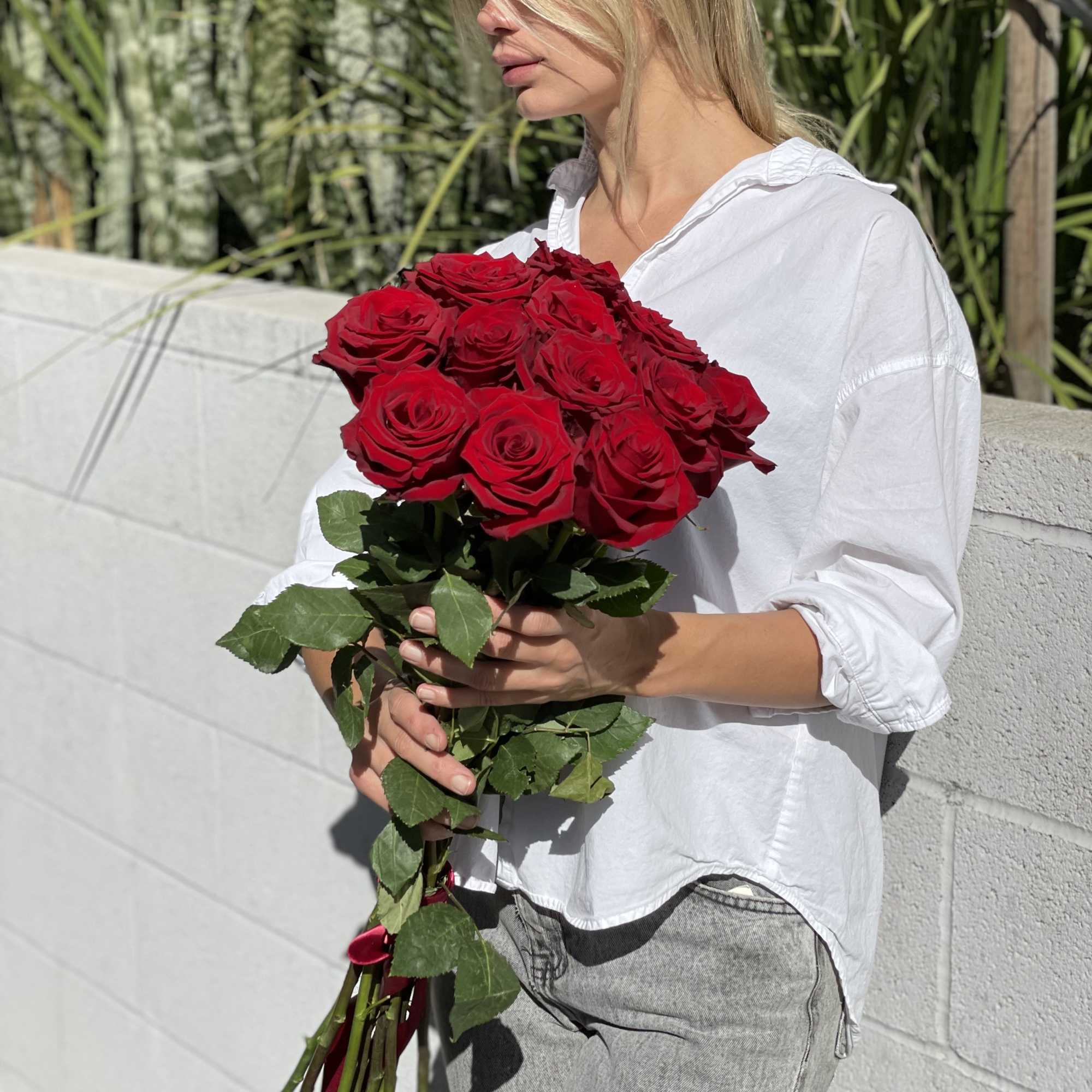 Woman holding a bouquet of red roses, photo 9 of 13