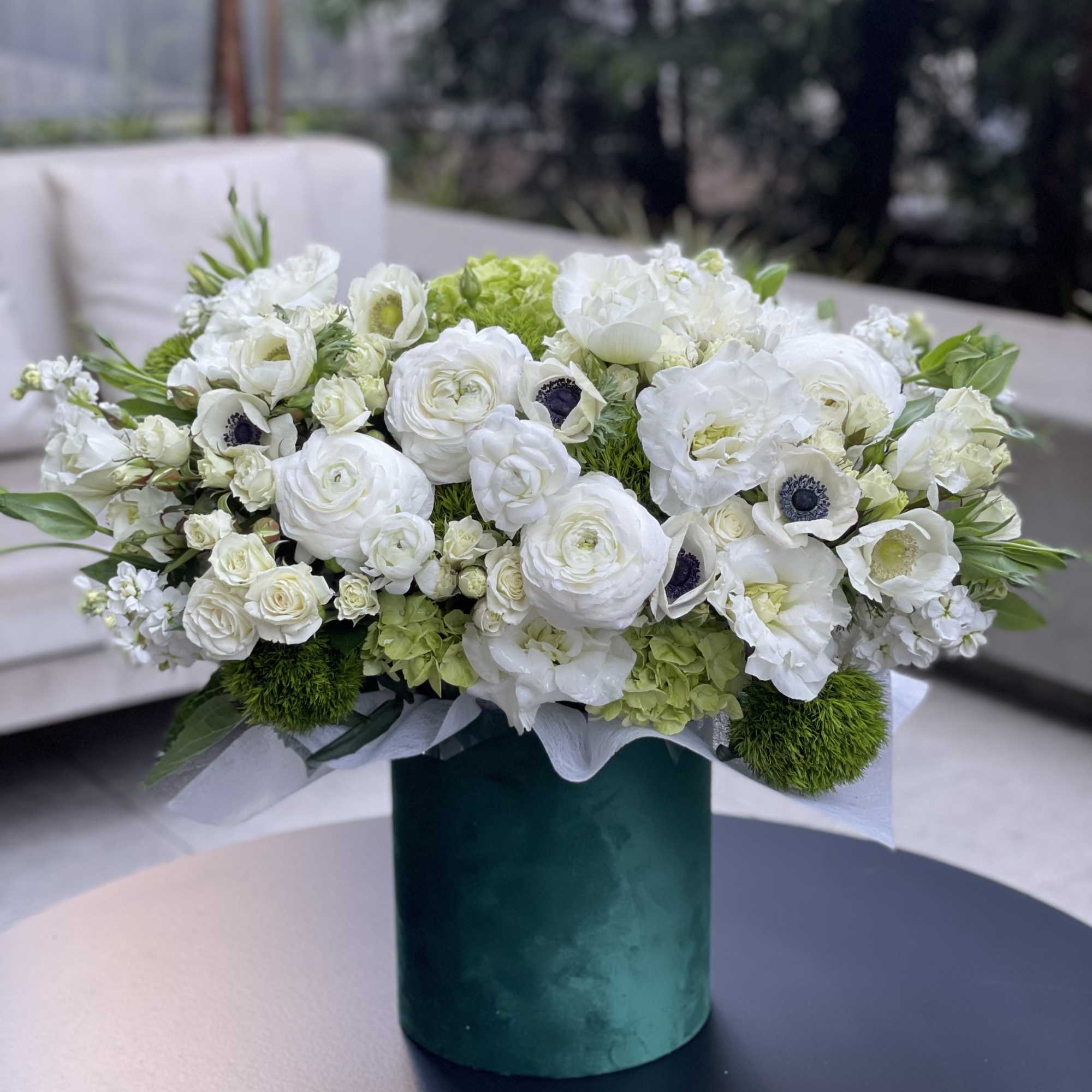 White floral arrangement in a green cylindrical vase, photo 6 of 9