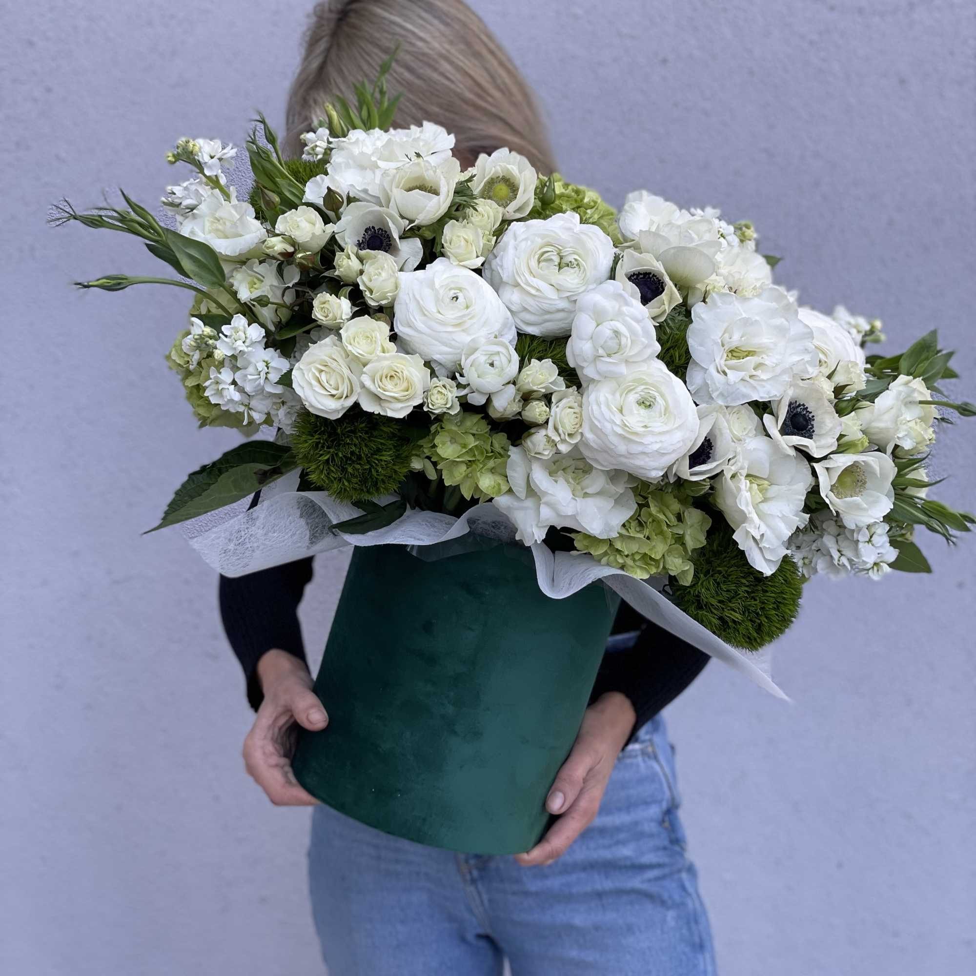 Large white flower bouquet in a green box