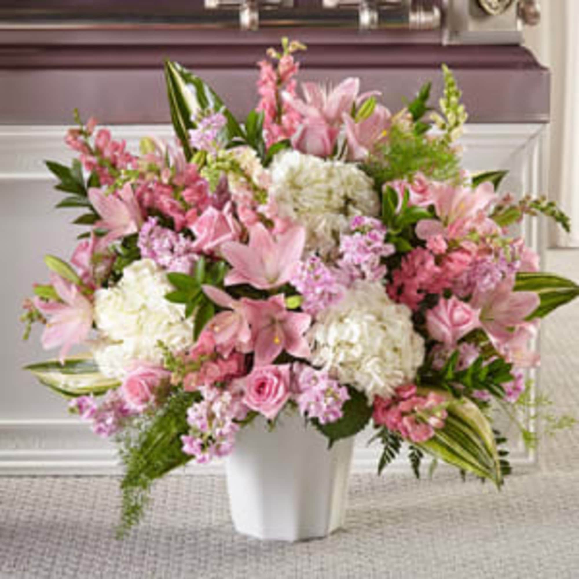 Pink and white mixed flower arrangement in a white vase, photo 2 of 3