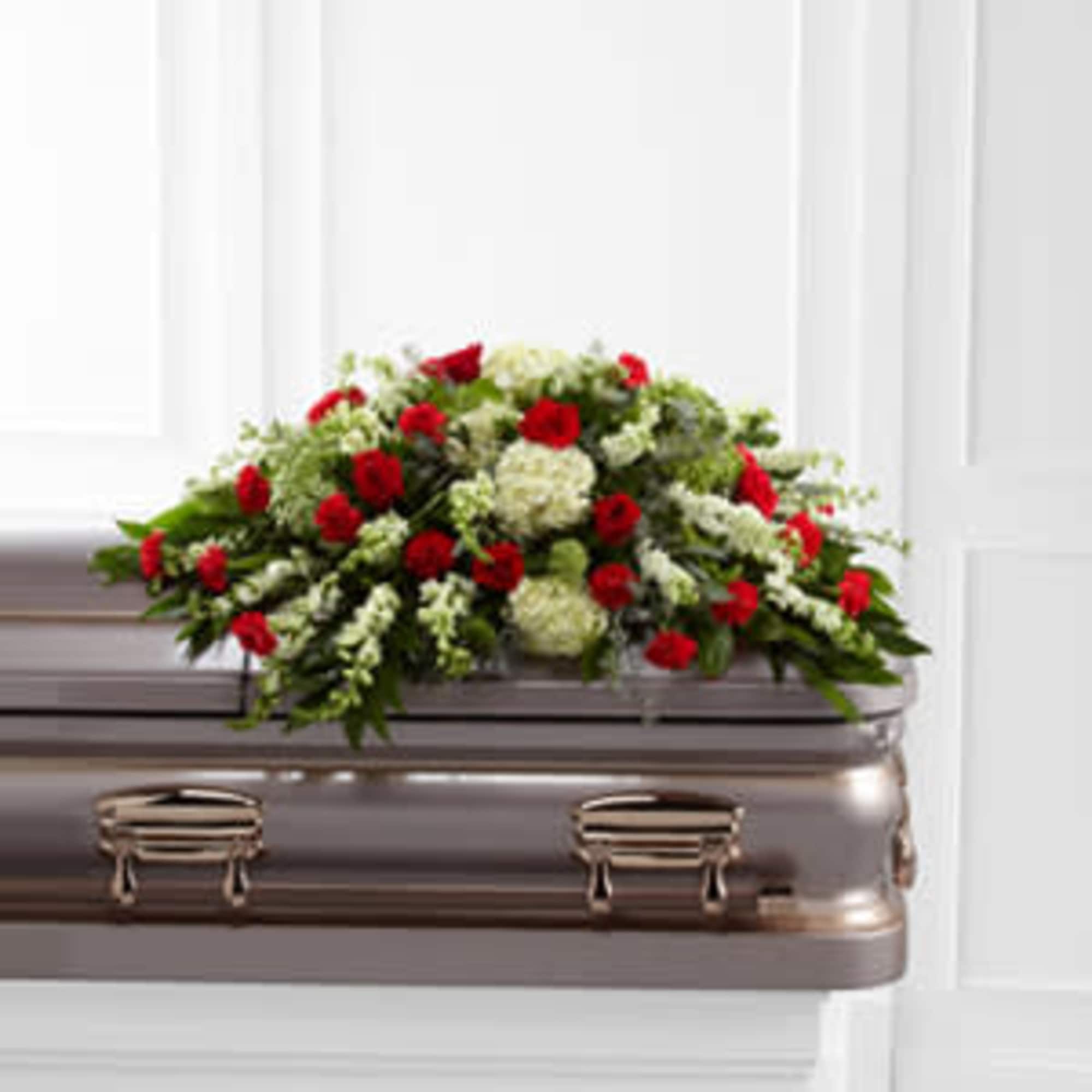 Red and white floral spray on a casket, photo 2 of 3