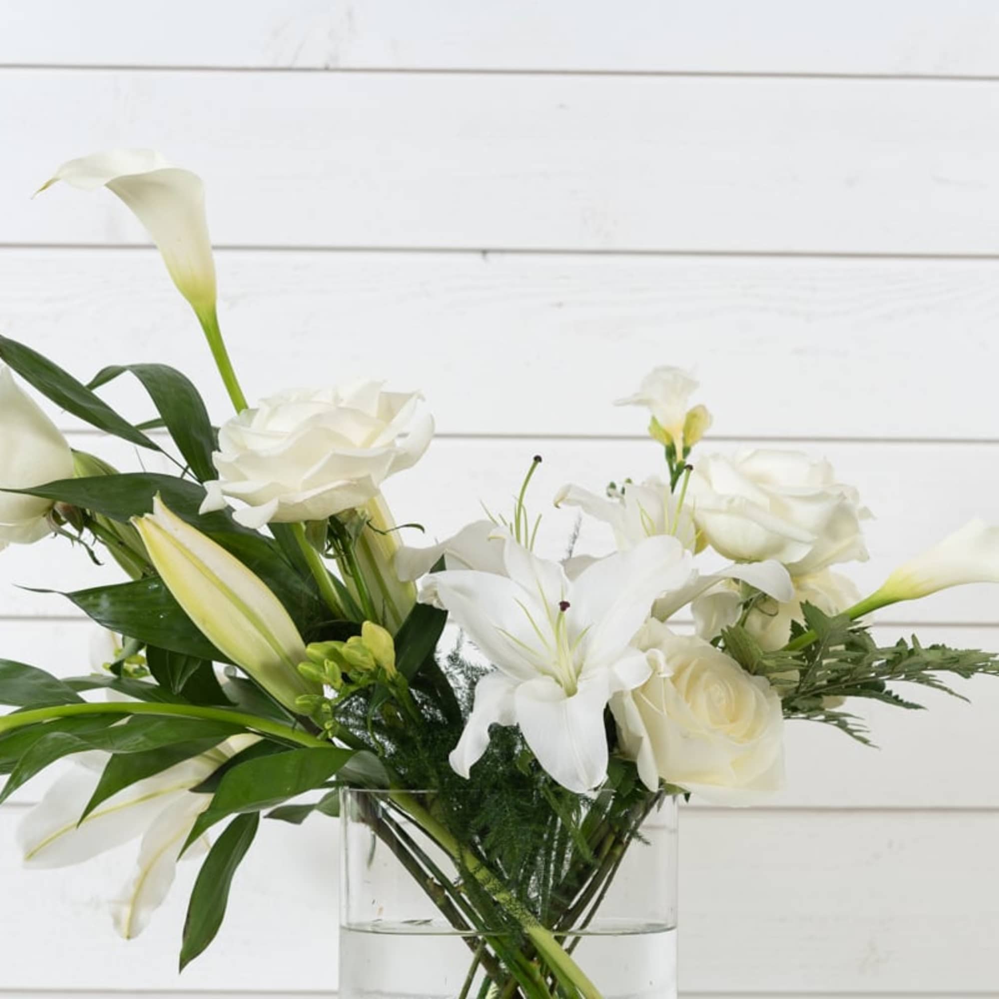 White flowers arranged in a clear glass vase