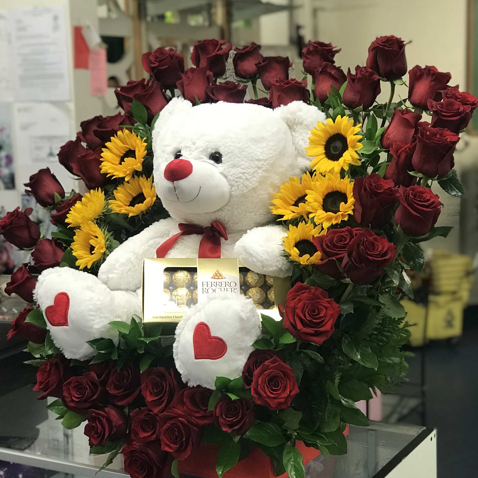 This arrangement has about 55-60 roses in a heart shape arch where, photo 2 of 3