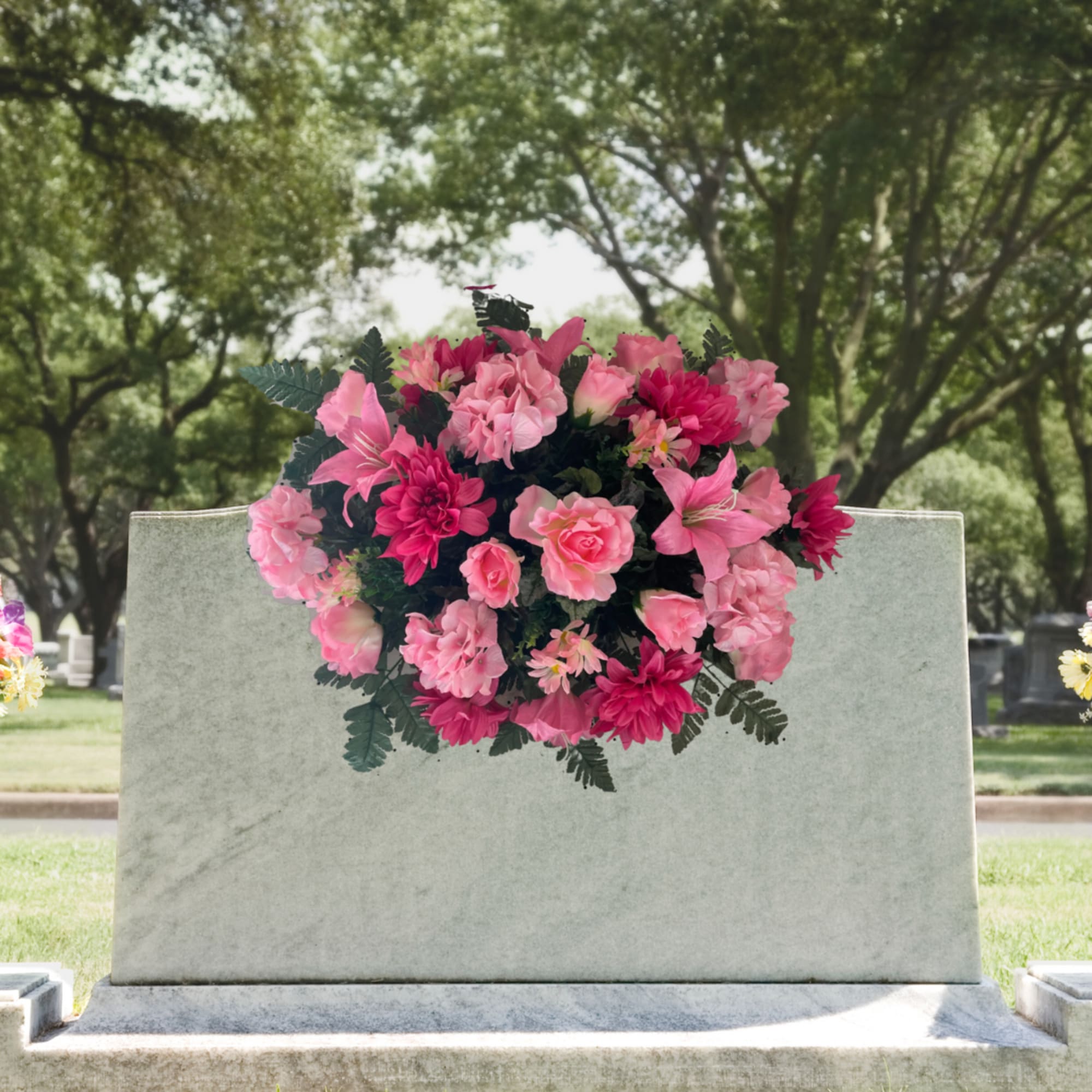 Pink floral spray on a gravestone in a cemetery