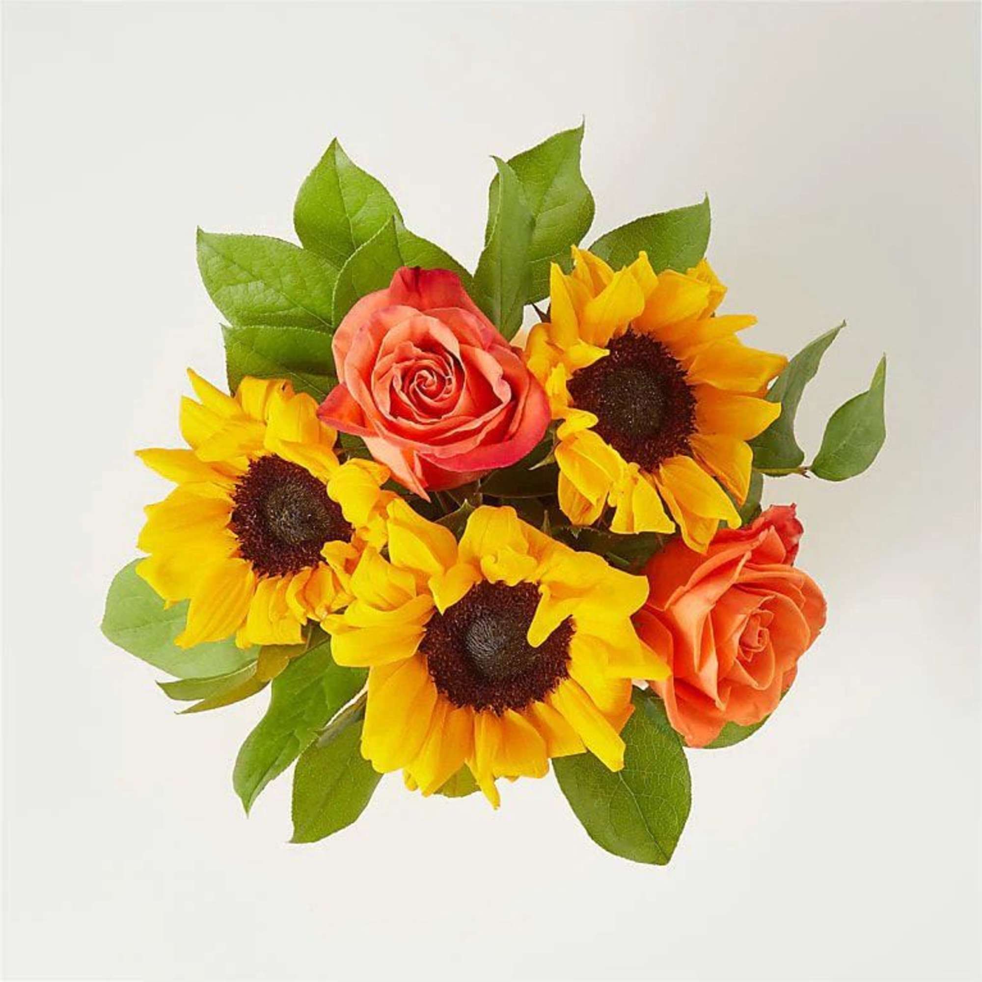 A bright and colorful centerpiece arranged in a ceramic pumpkin container. This, photo 2 of 2
