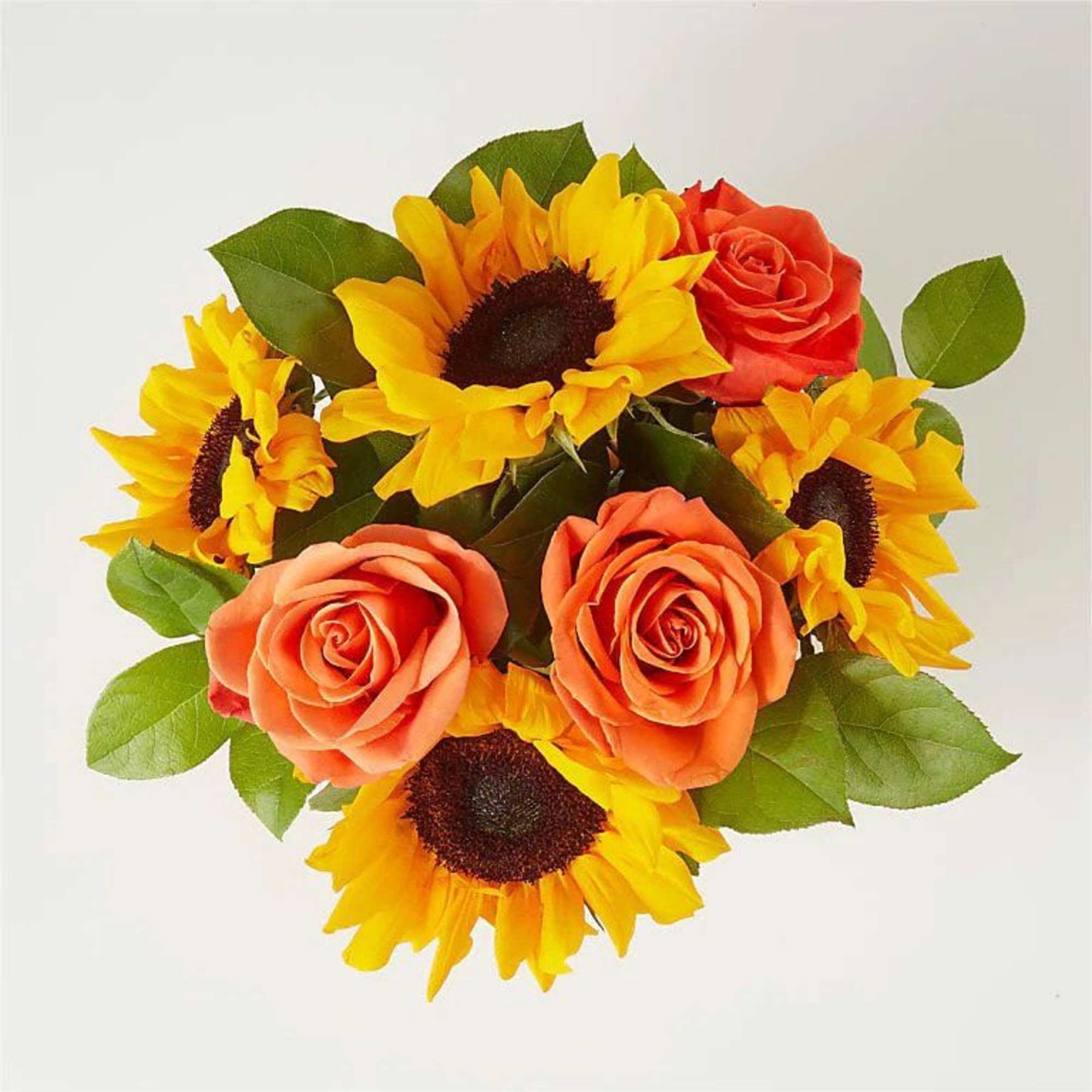 A bright and colorful centerpiece arranged in a ceramic pumpkin container. This, photo 2 of 2
