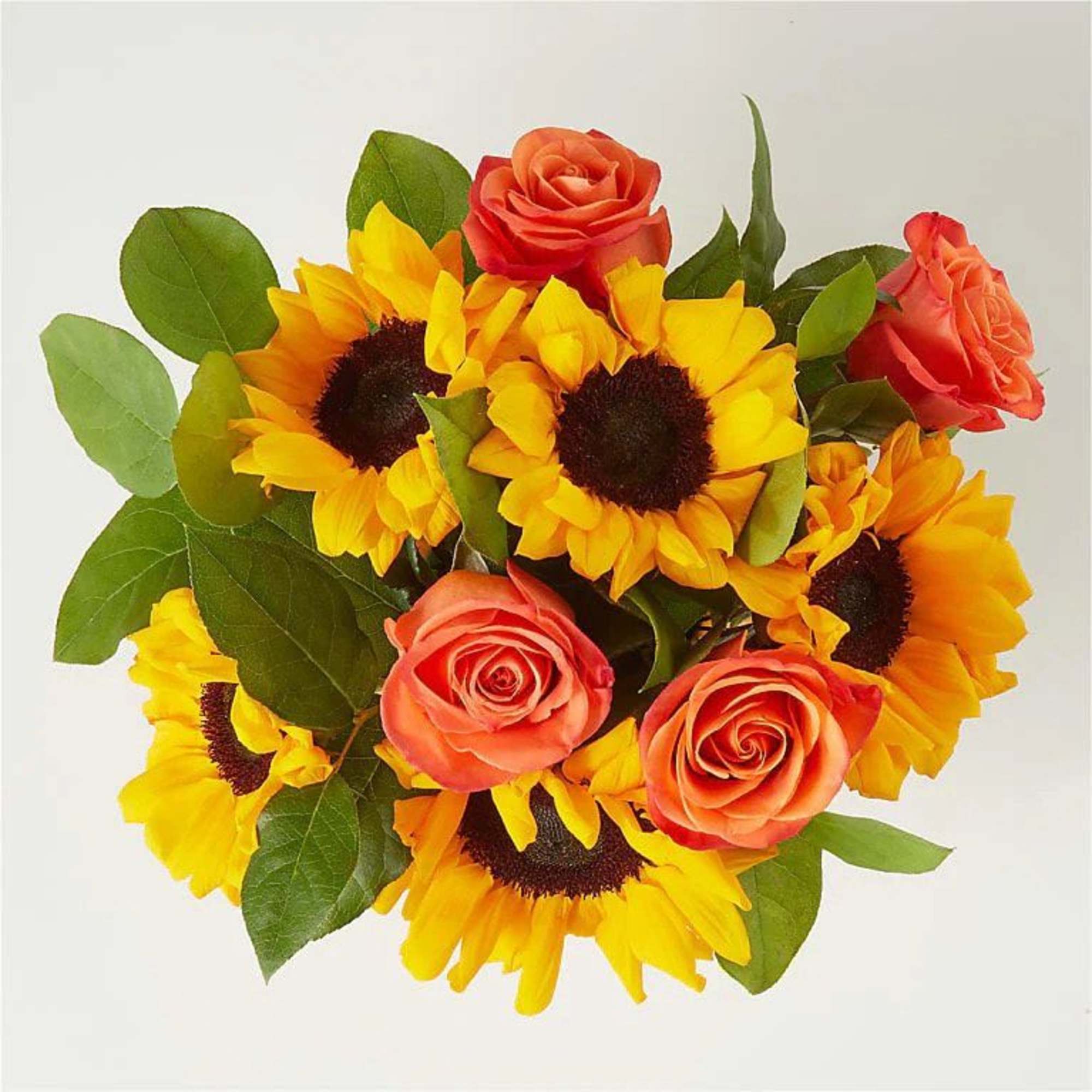 A bright and colorful centerpiece arranged in a ceramic pumpkin container. This, photo 2 of 2