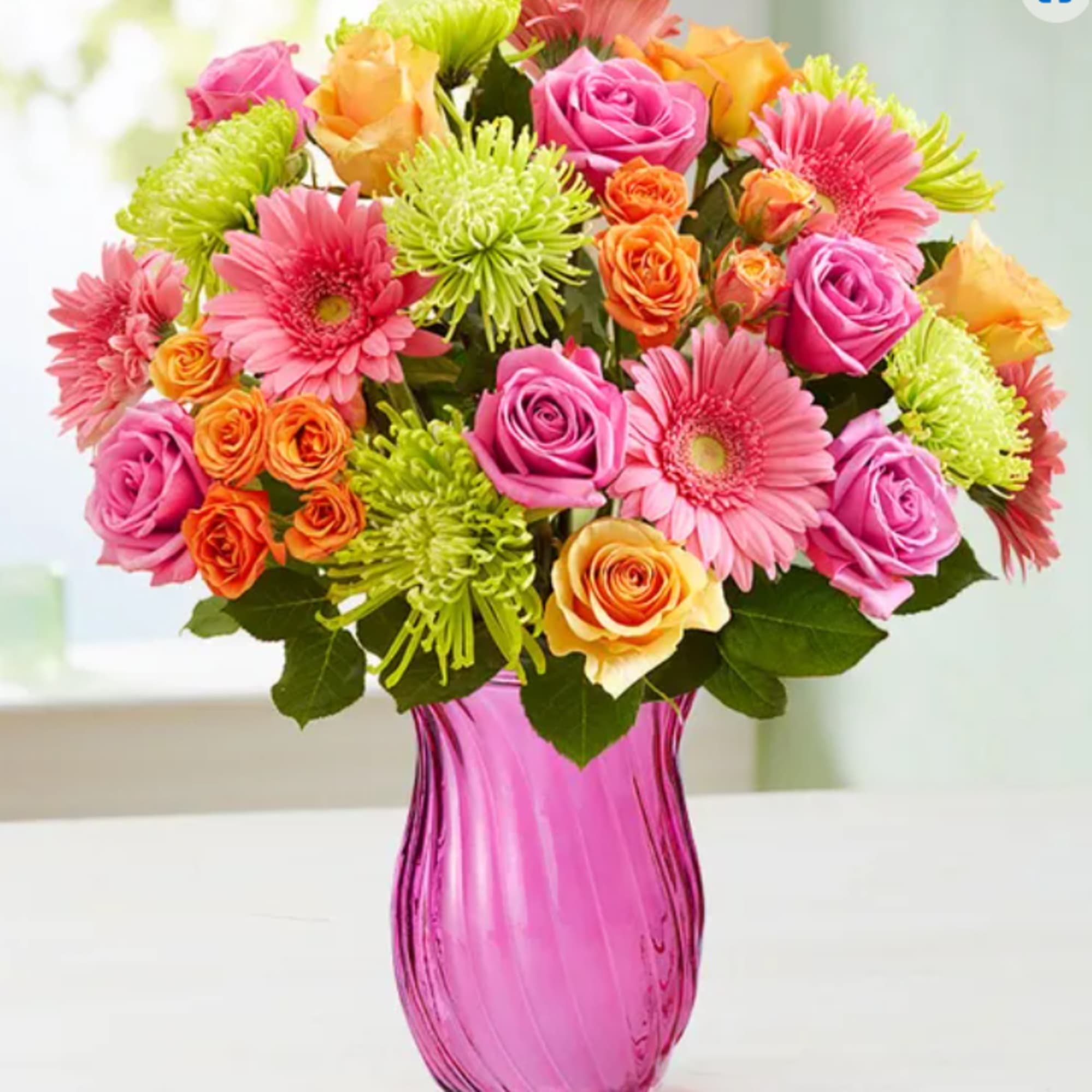 colorful mix of available flowers. comes in a colored or clear vase