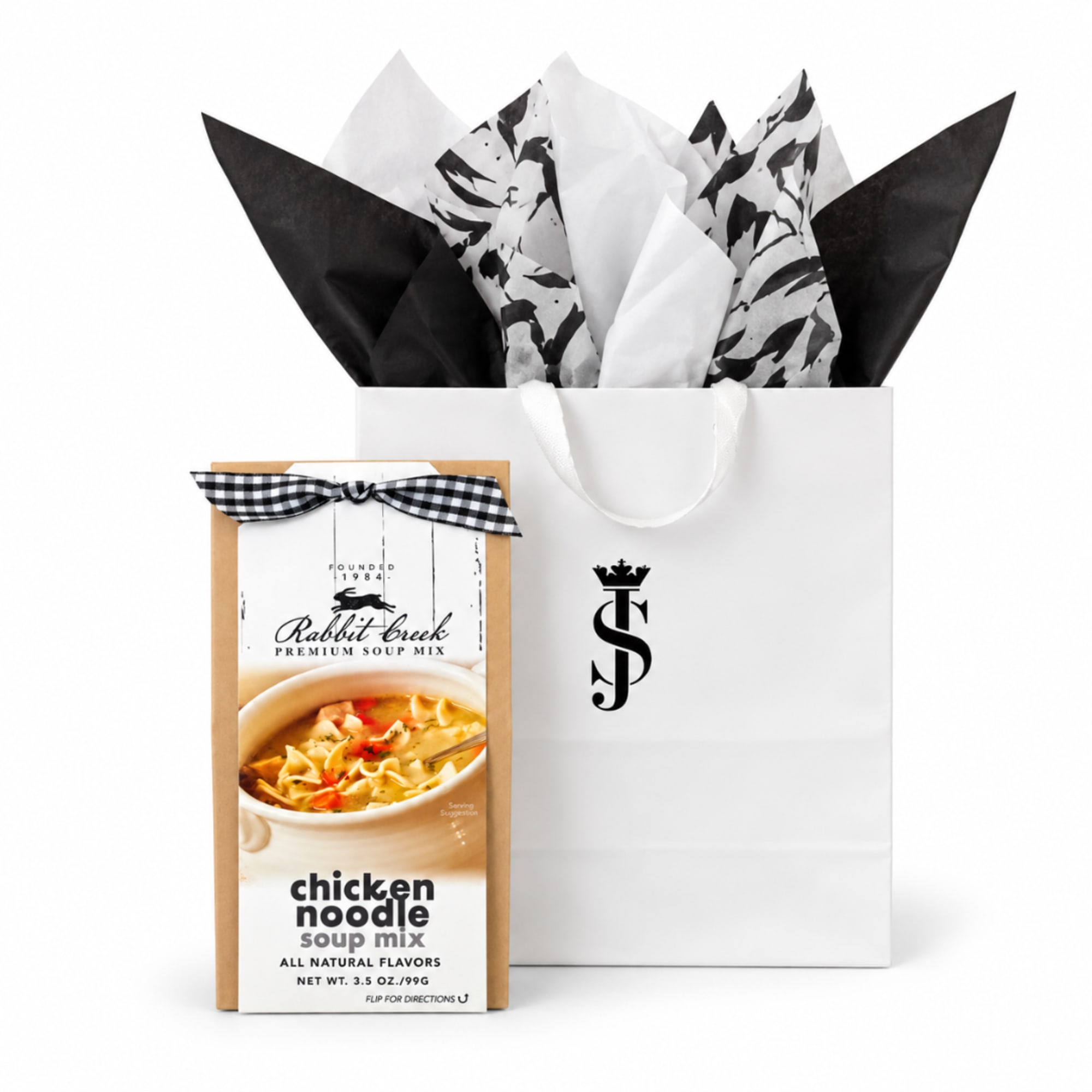 Gift bag with tissue paper and a boxed chicken noodle soup mix