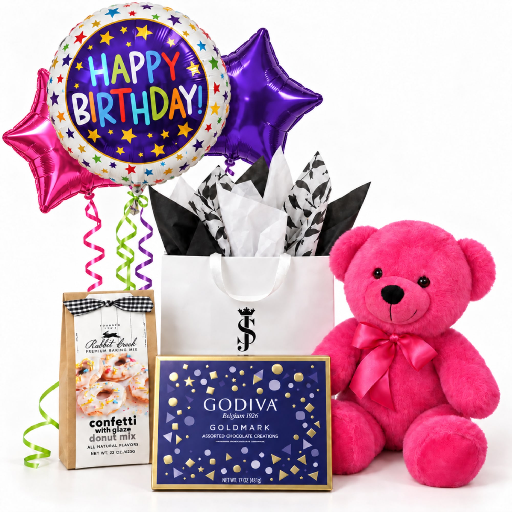 Birthday balloon bouquet with a pink teddy bear, chocolates, and baking mix