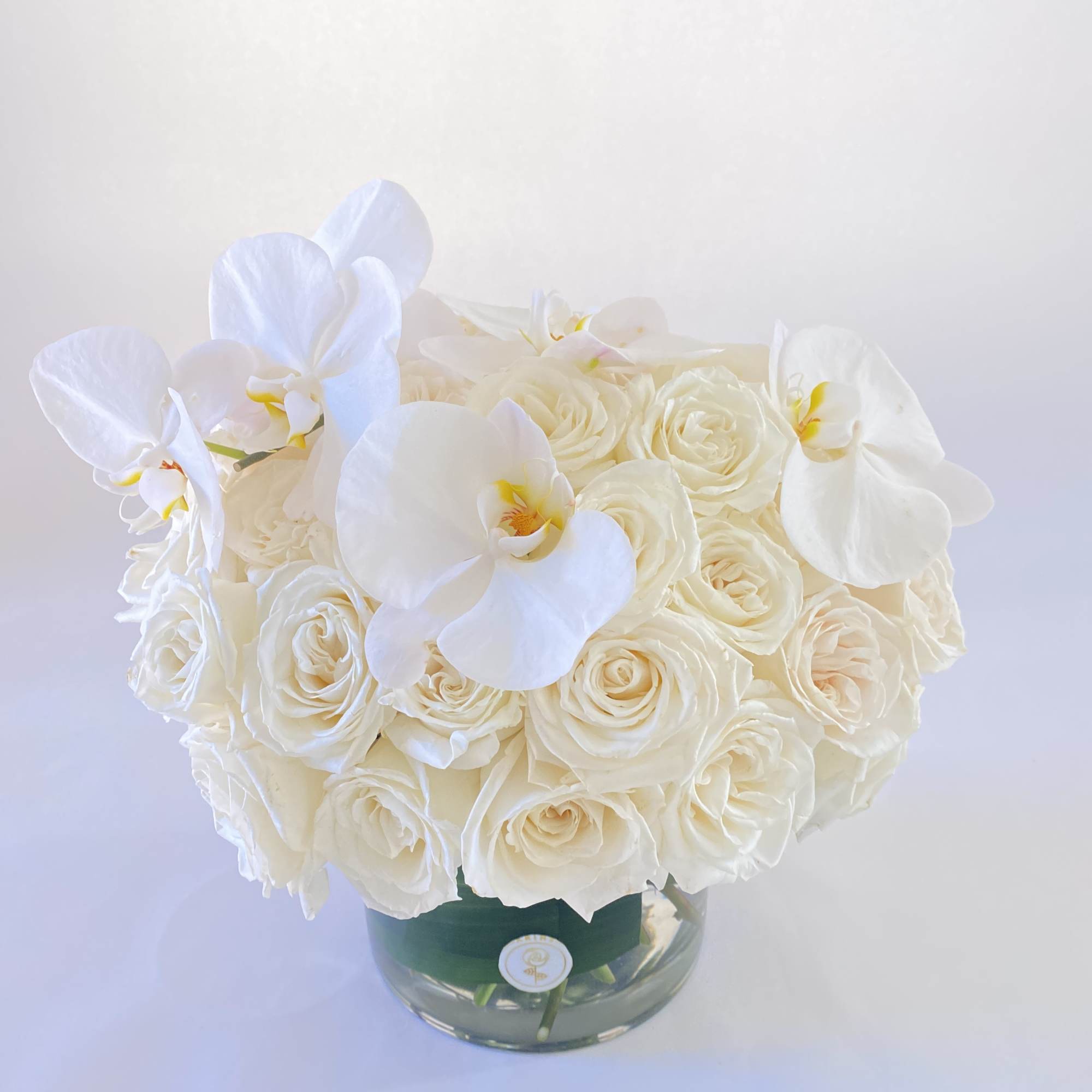 White rose bouquet with white orchids in a glass vase, photo 2 of 2