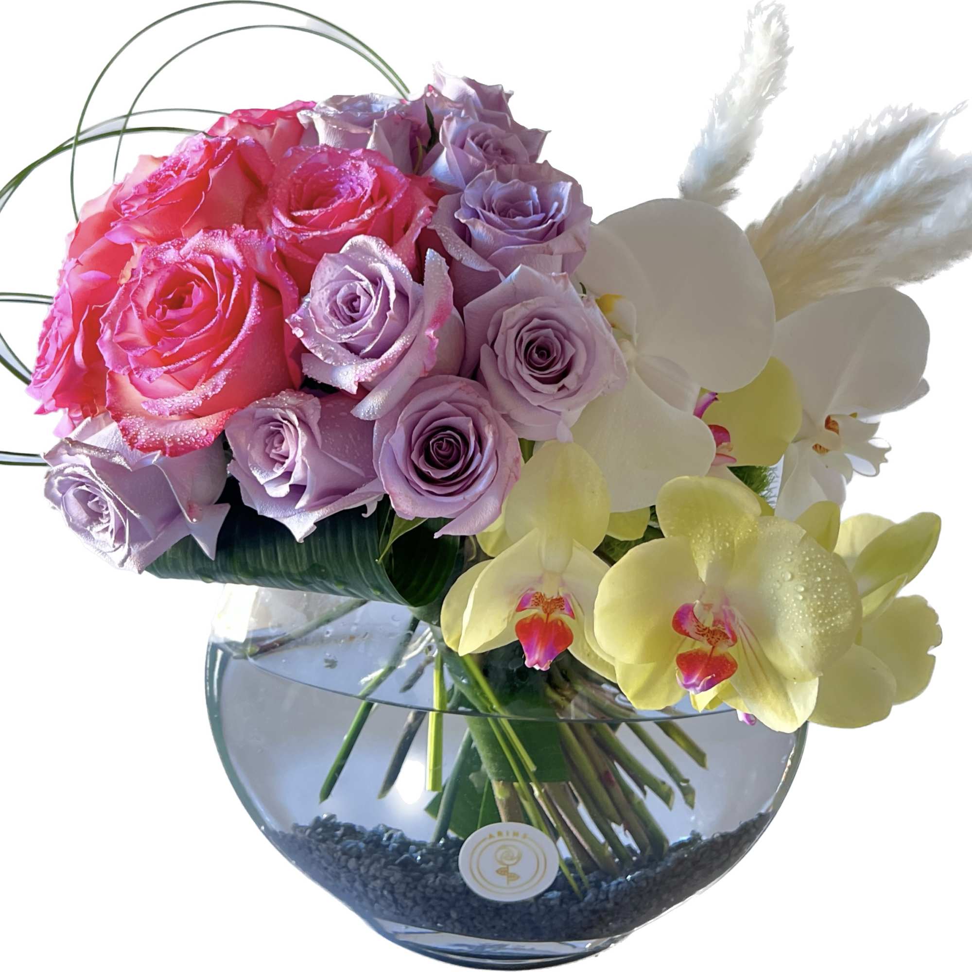 Pink and lavender roses with white orchids in a glass vase