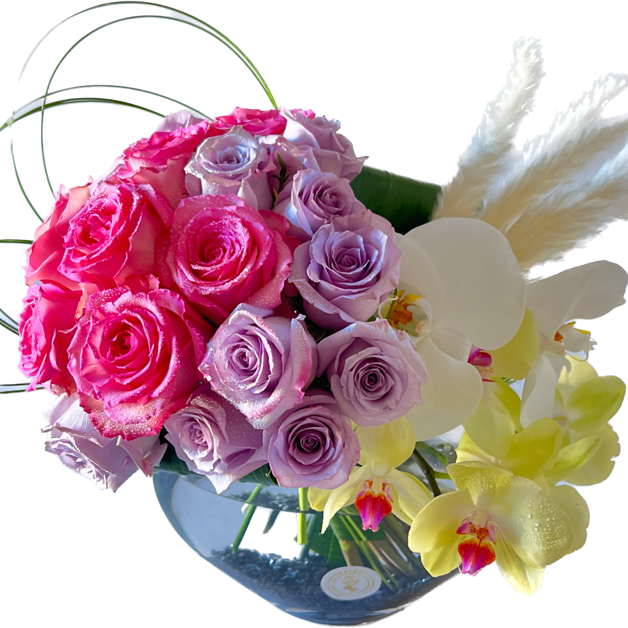 Bouquet of pink and lavender roses with white and yellow orchids in a glass vase