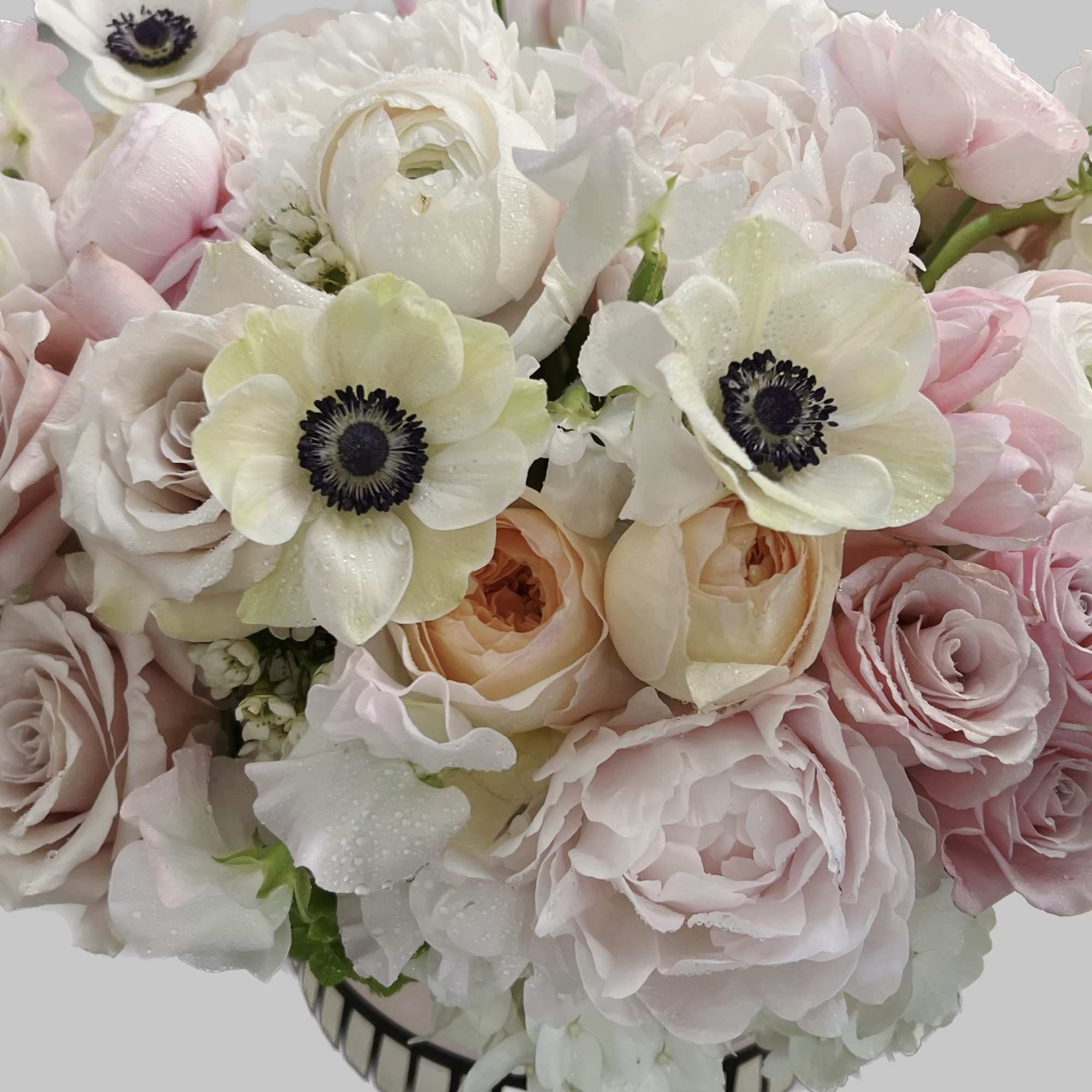 Bouquet of pale pink and white flowers with dark-centered blooms