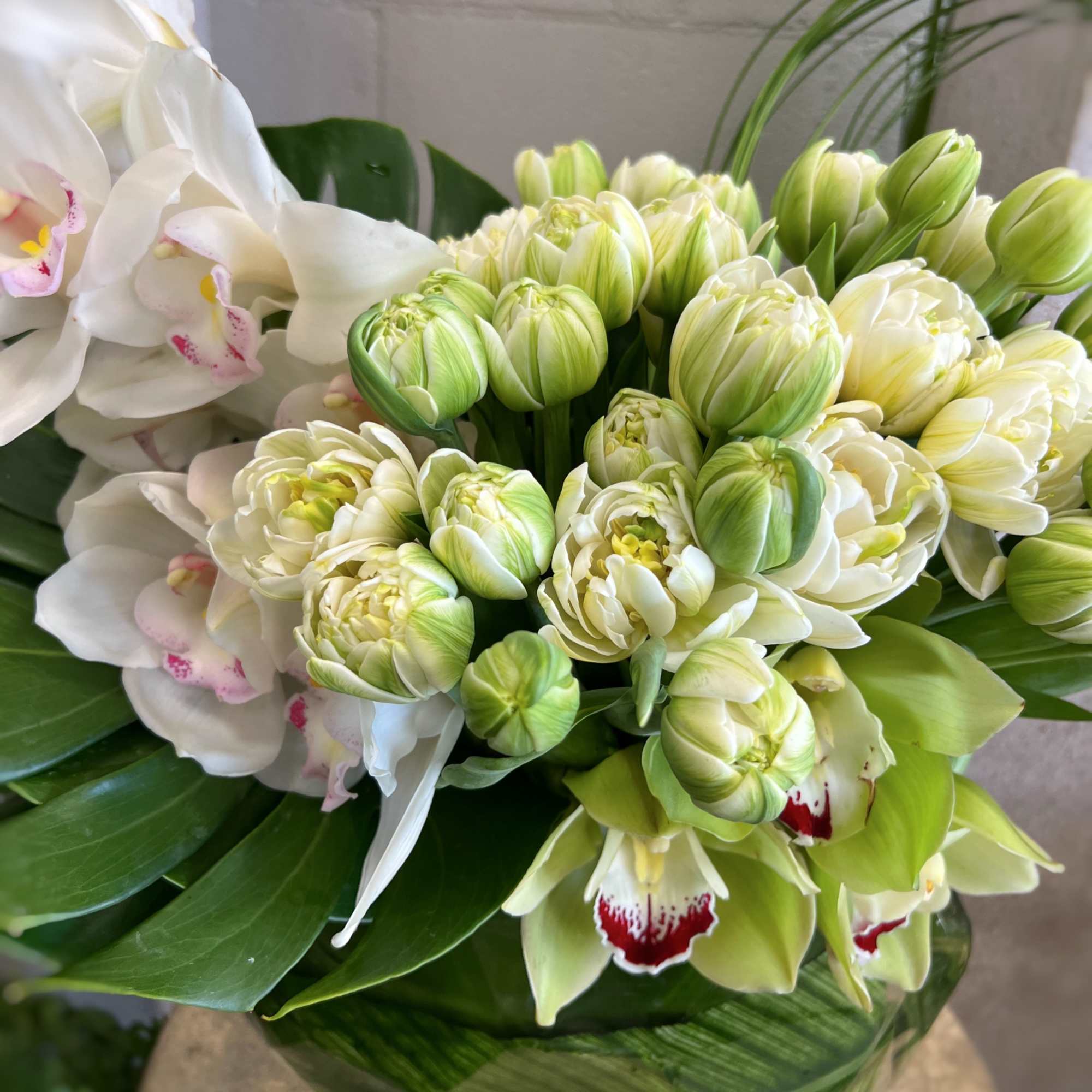 Bouquet of green and white flowers with orchids and tulips