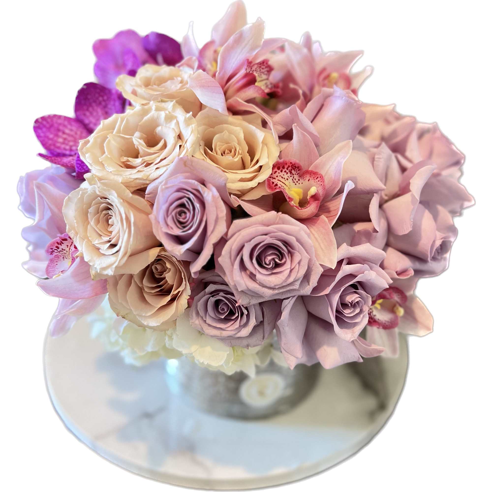 Bouquet of pastel roses and orchids in a glass vase