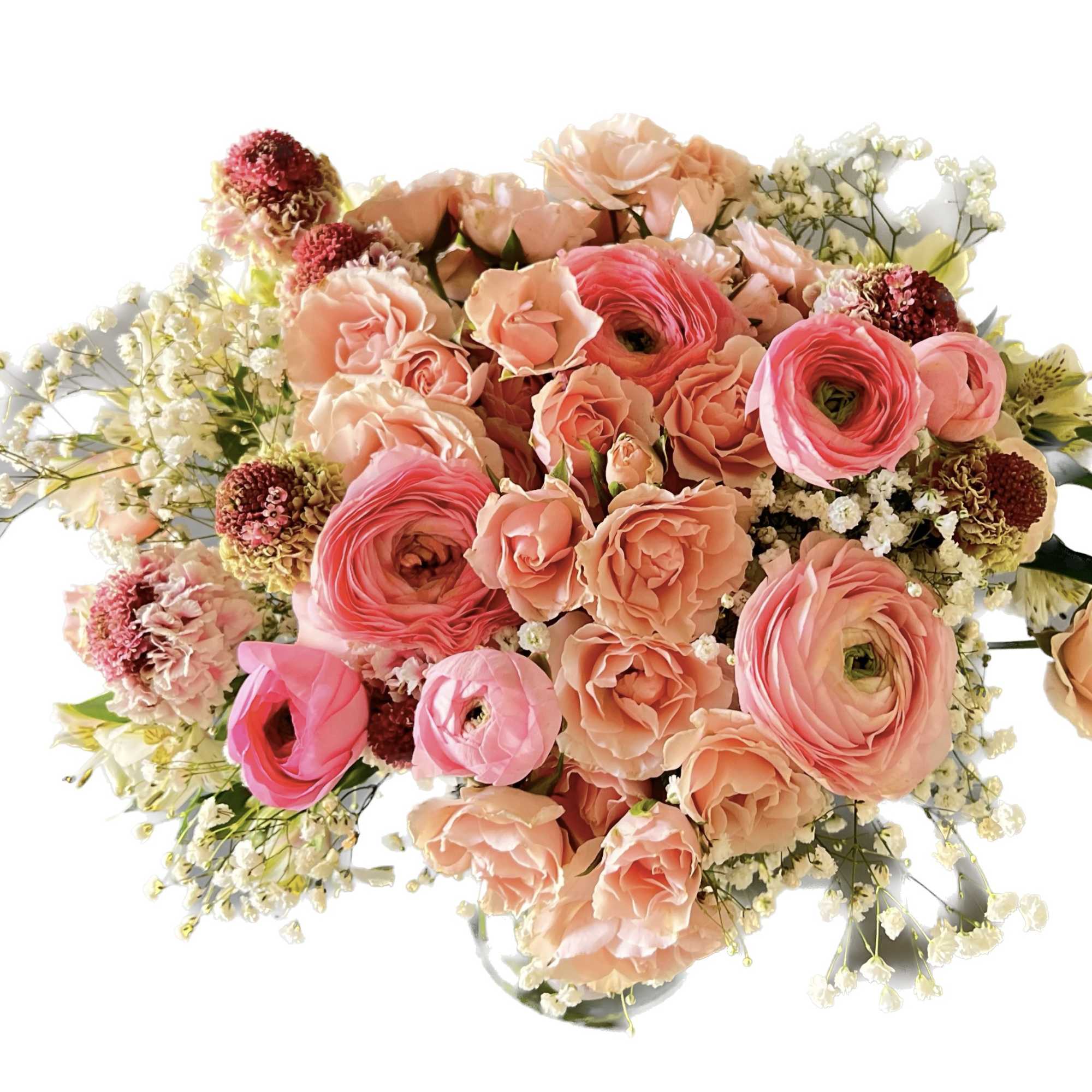 Bouquet of peach and pink flowers with white filler in a vase