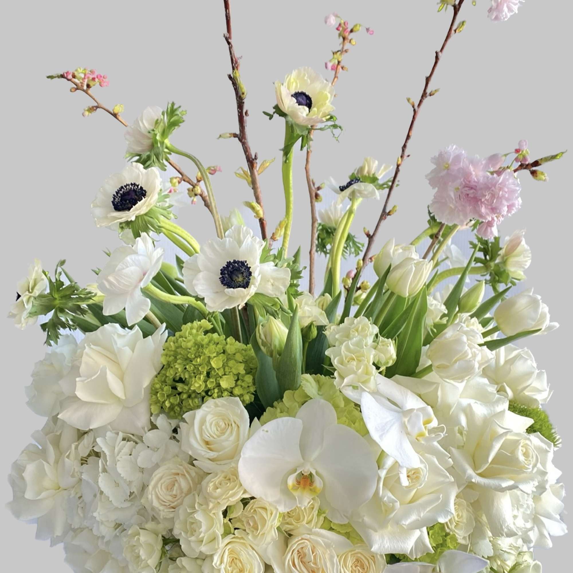 White floral arrangement with pink blossoms in a vase