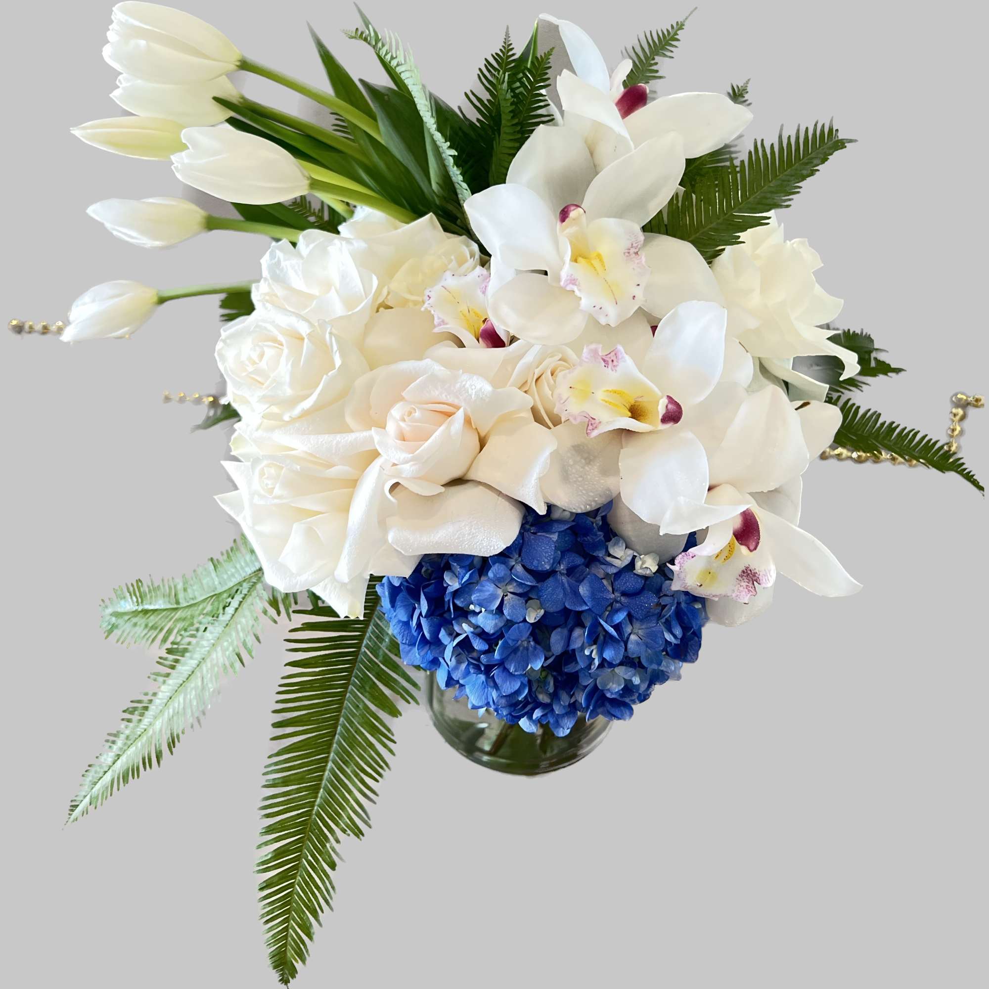 A blue and white arrangement in a clear glass vase, this arrangement, photo 2 of 2