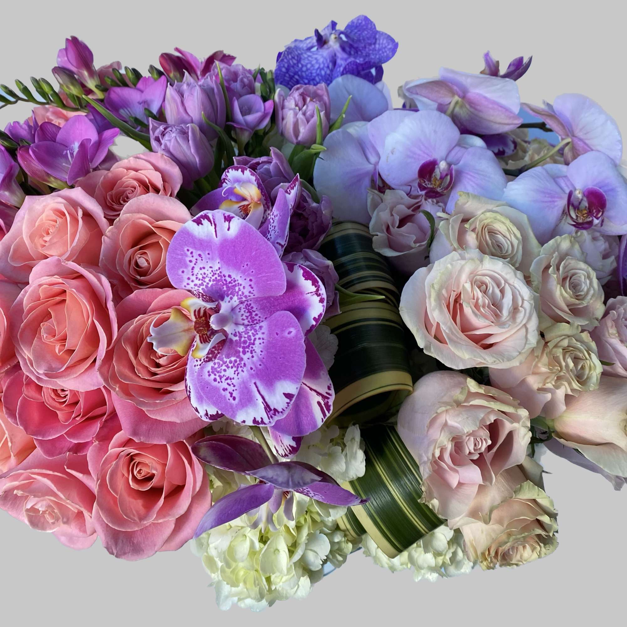Bouquet of pink roses, purple orchids, and lavender tulips
