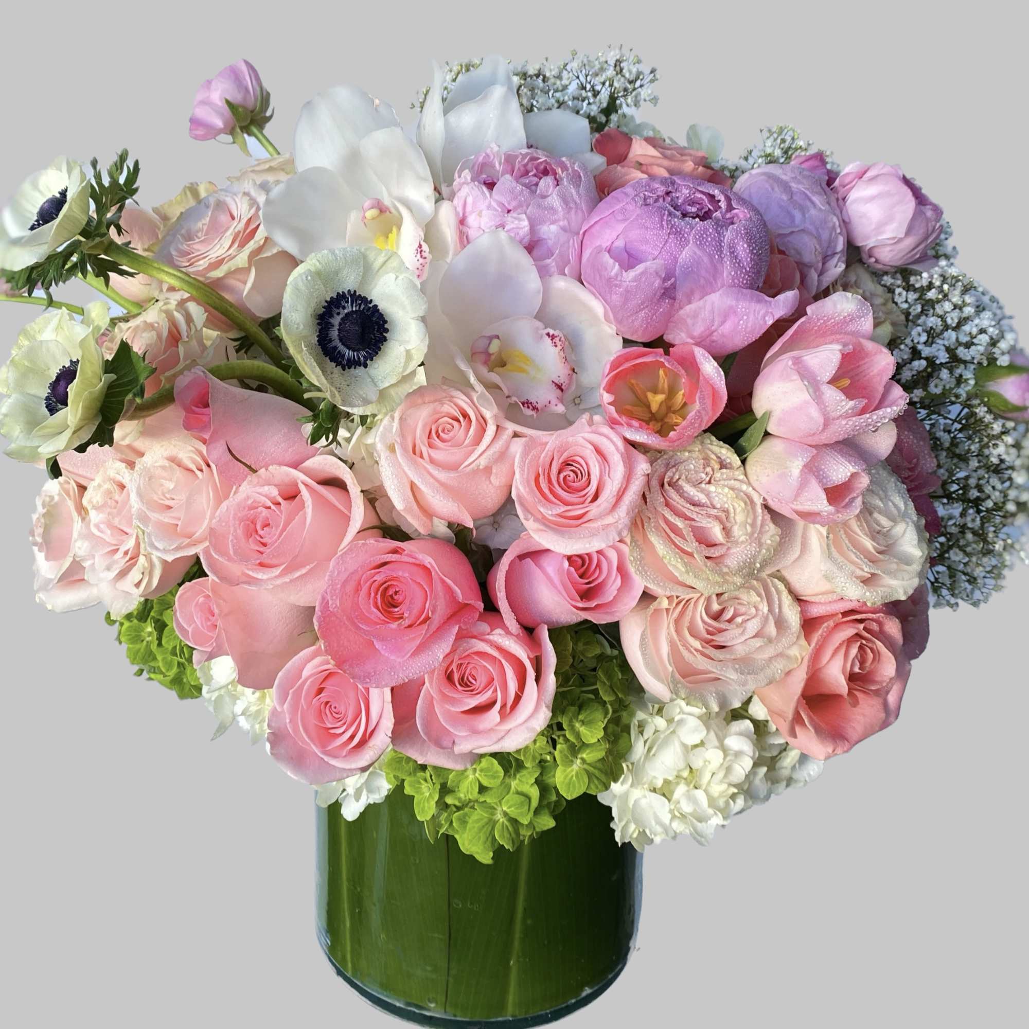 Pink and white mixed bouquet in a green glass vase