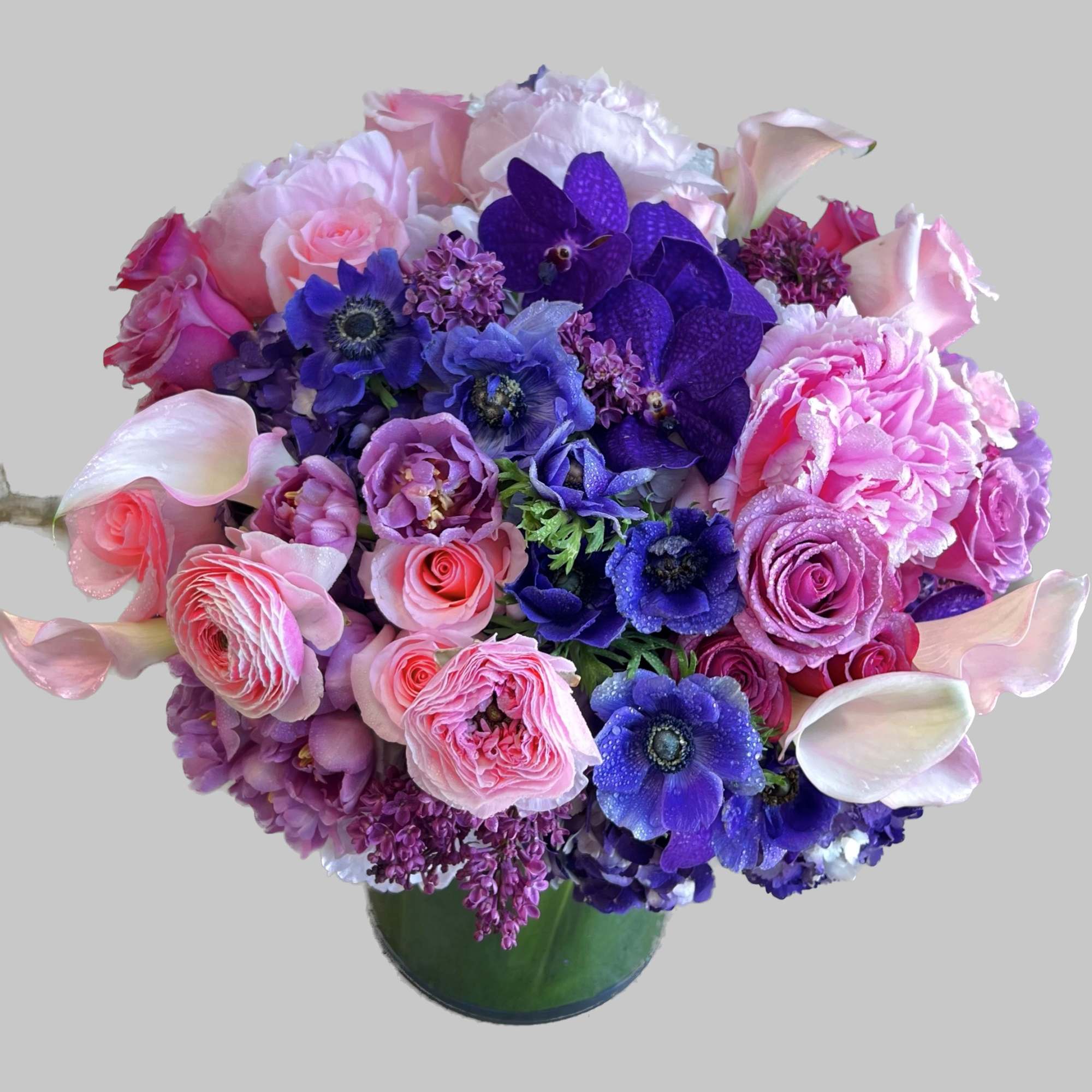 Pink and purple mixed bouquet in a green vase