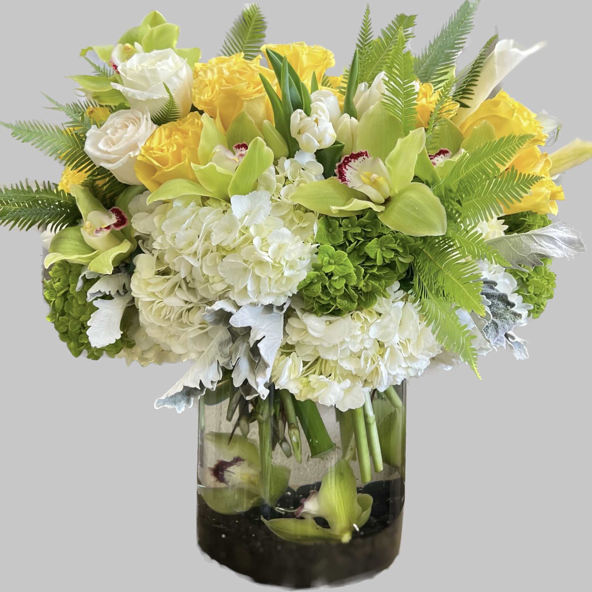 Yellow and white floral arrangement in a glass vase