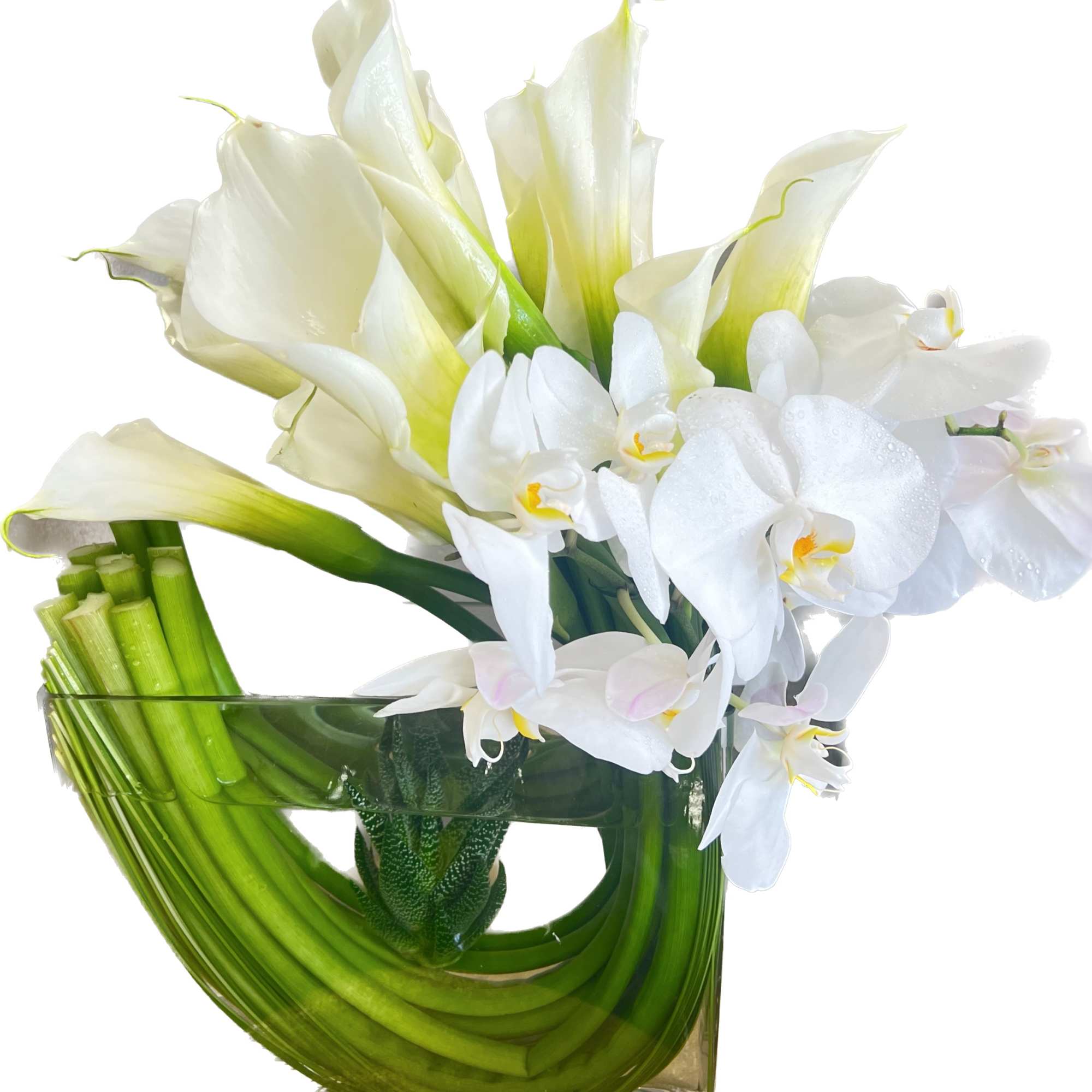 White calla lilies and orchids in a clear glass vase with curved green stems