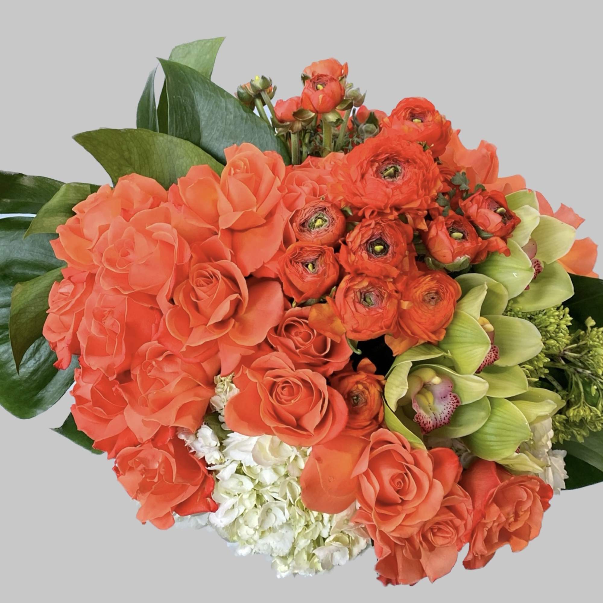 Bouquet of orange roses, ranunculus, and green orchids
