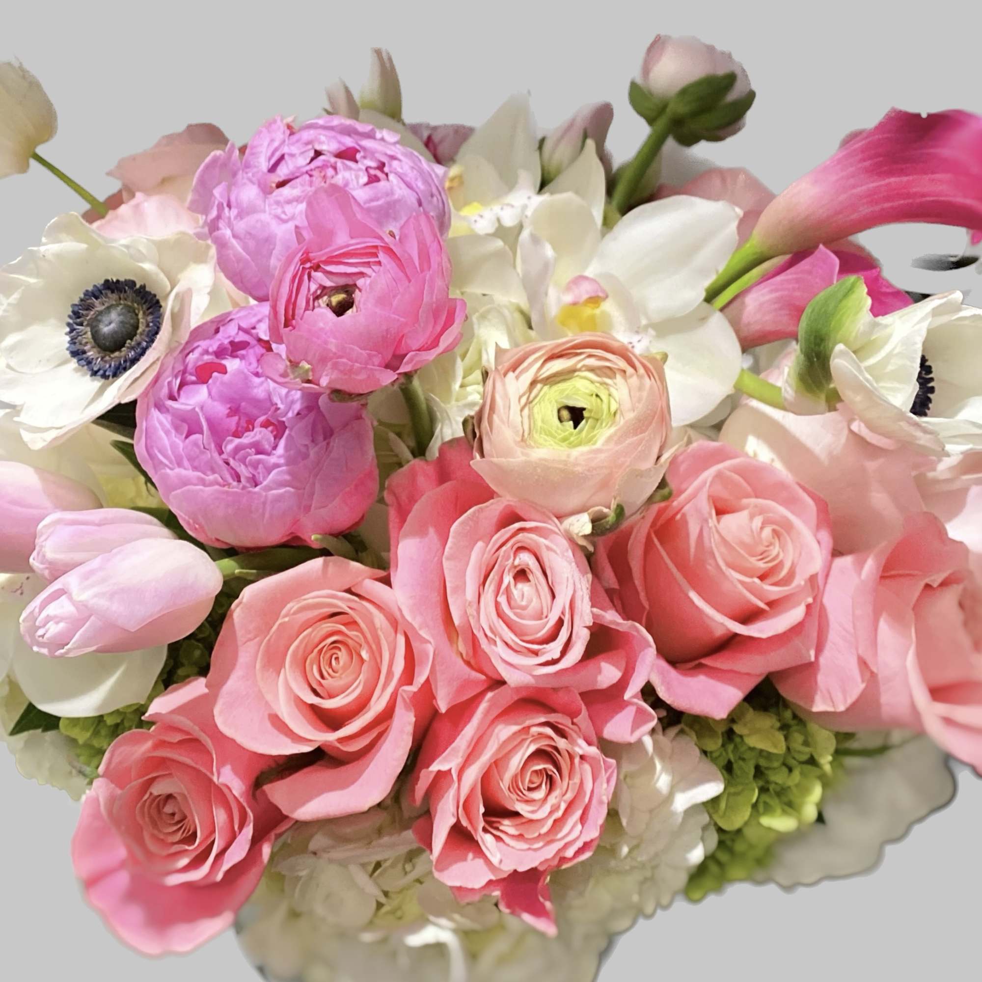 Pink roses and white anemones with calla lilies in a bouquet