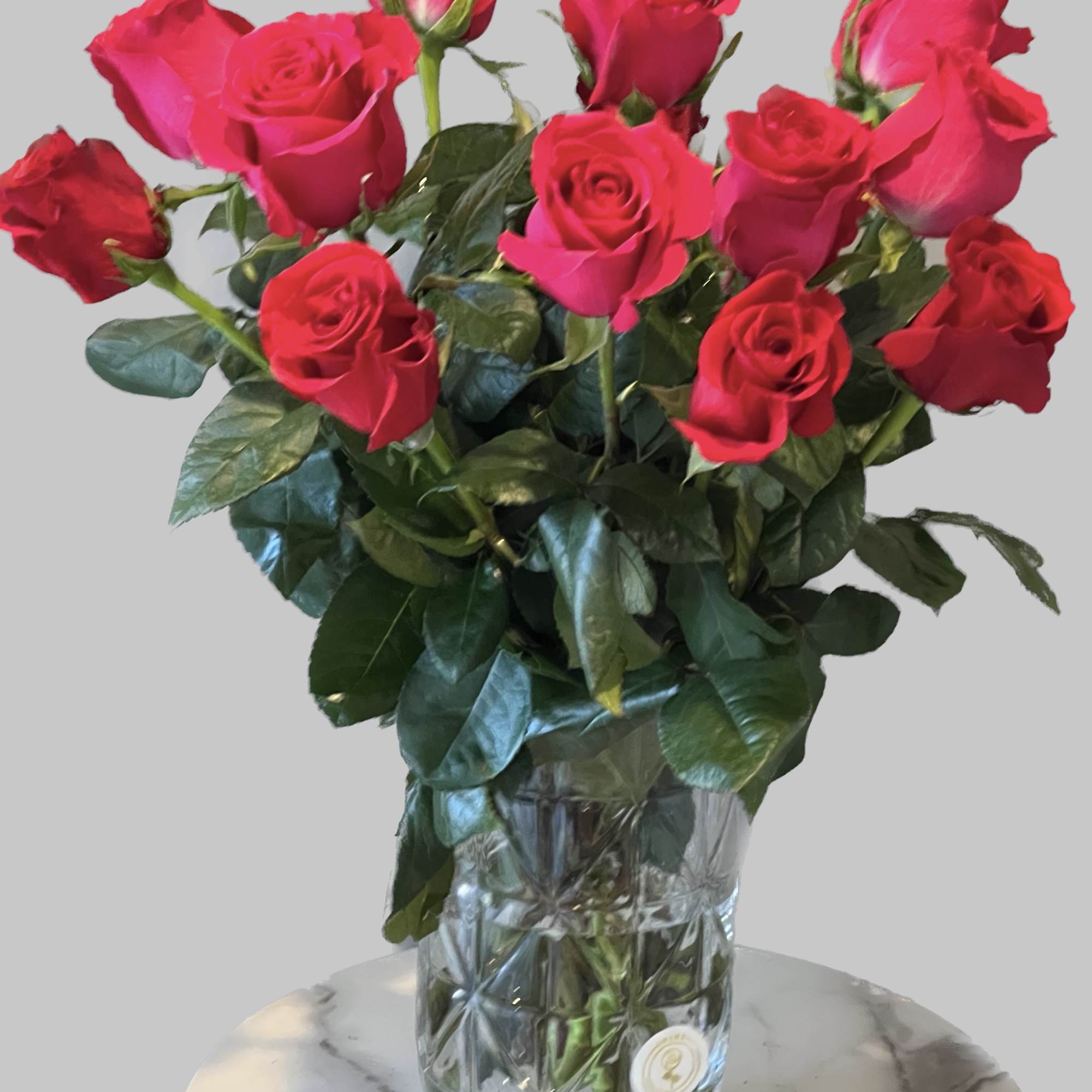 Bouquet of bright pink roses in a clear glass vase