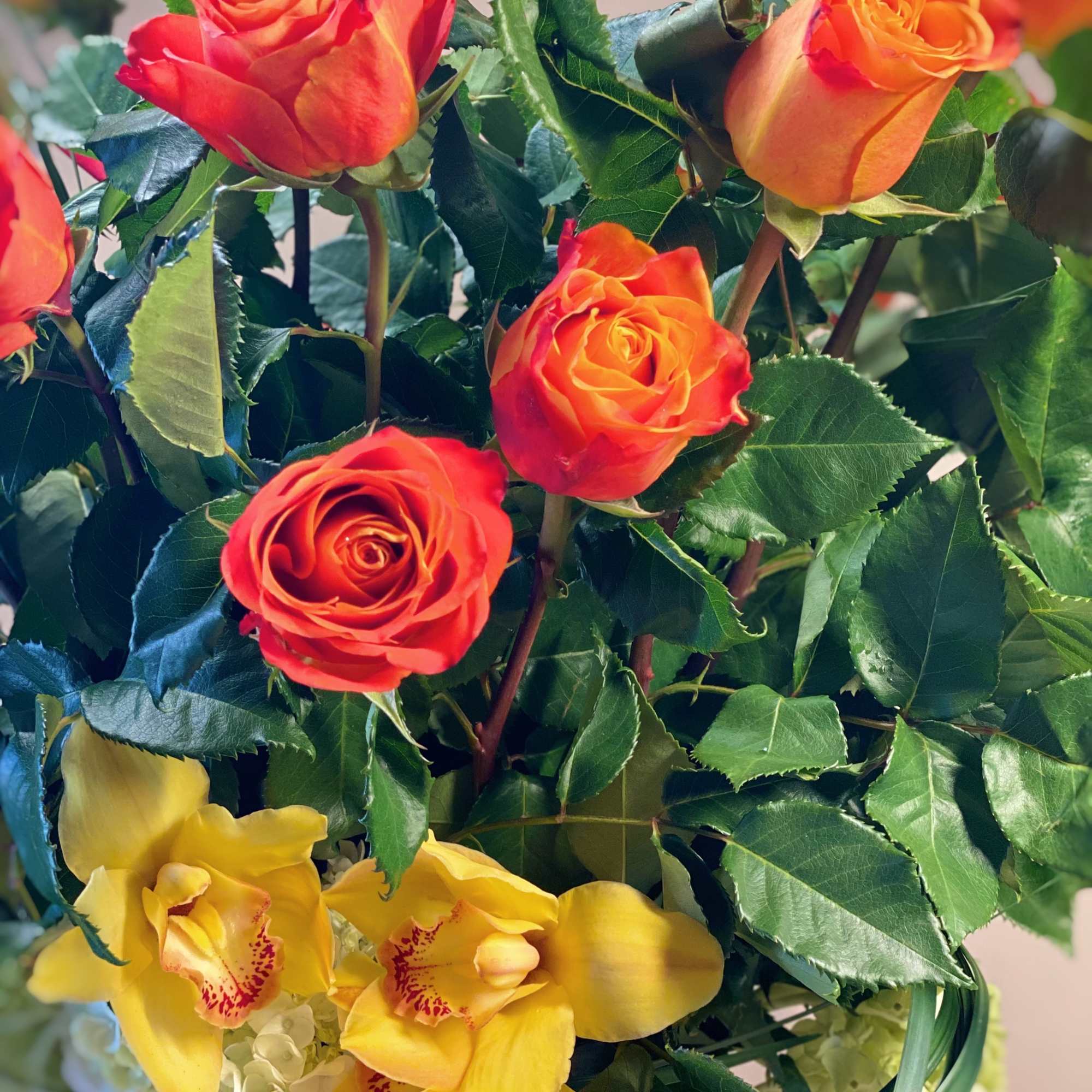 Bouquet of orange roses and yellow orchids
