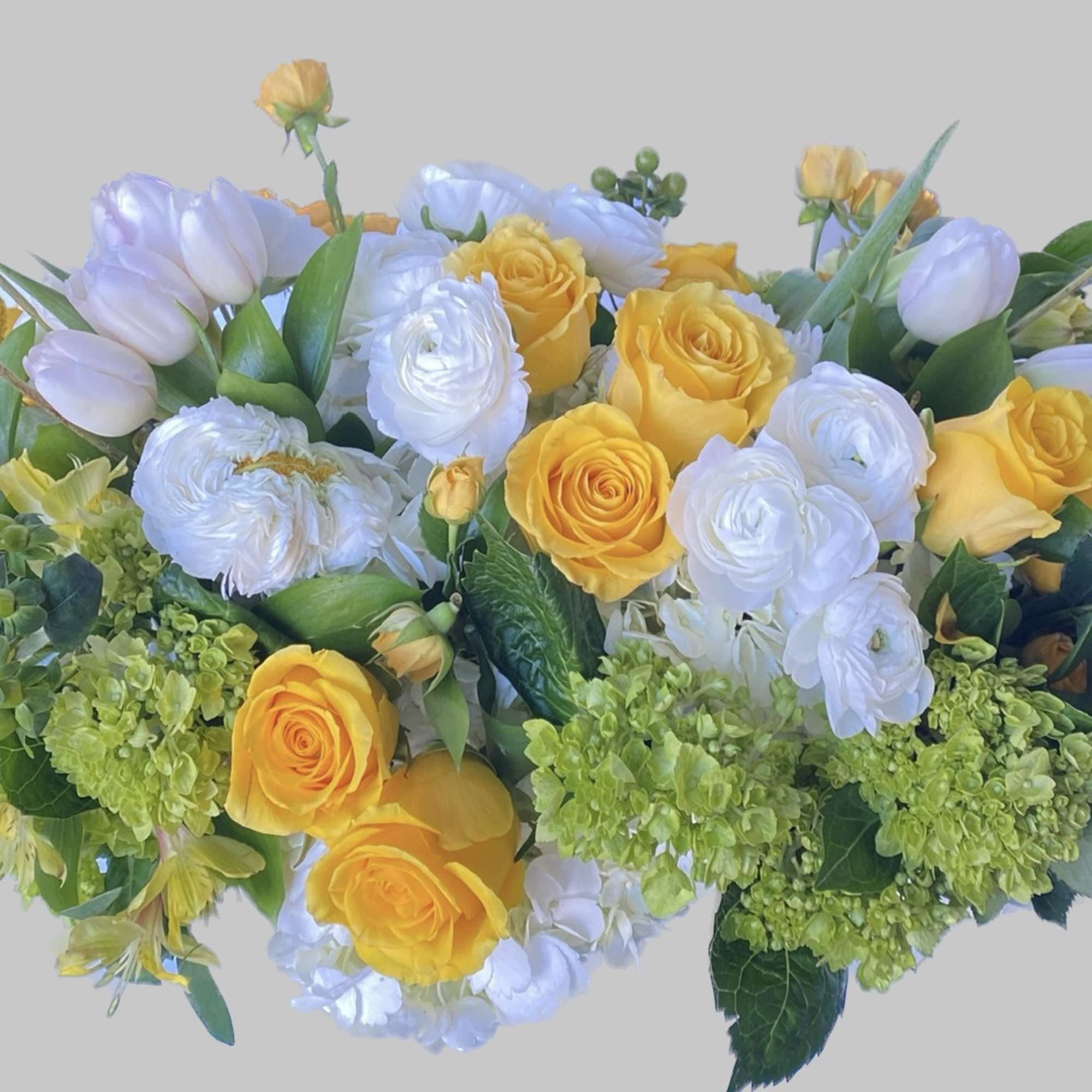Yellow and white floral arrangement with roses and tulips