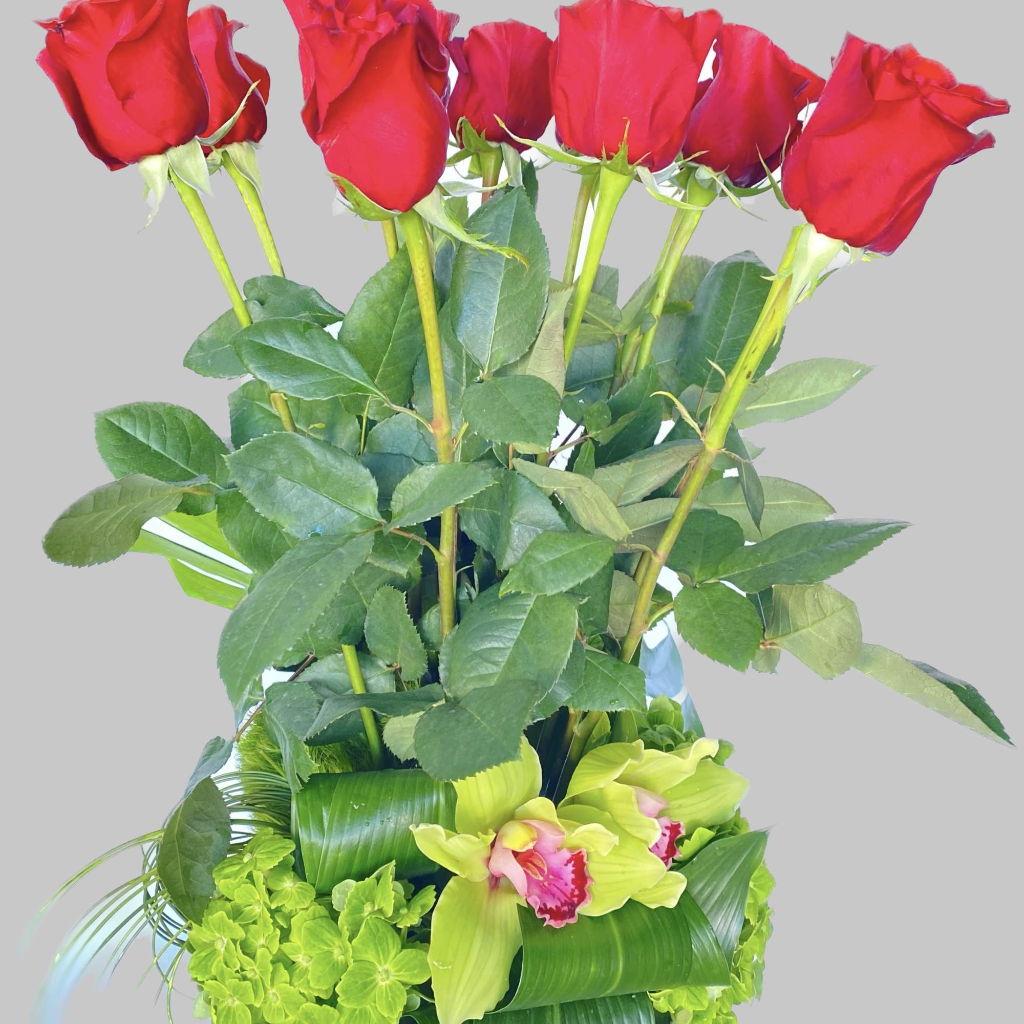 Bouquet of red roses with green orchids and foliage