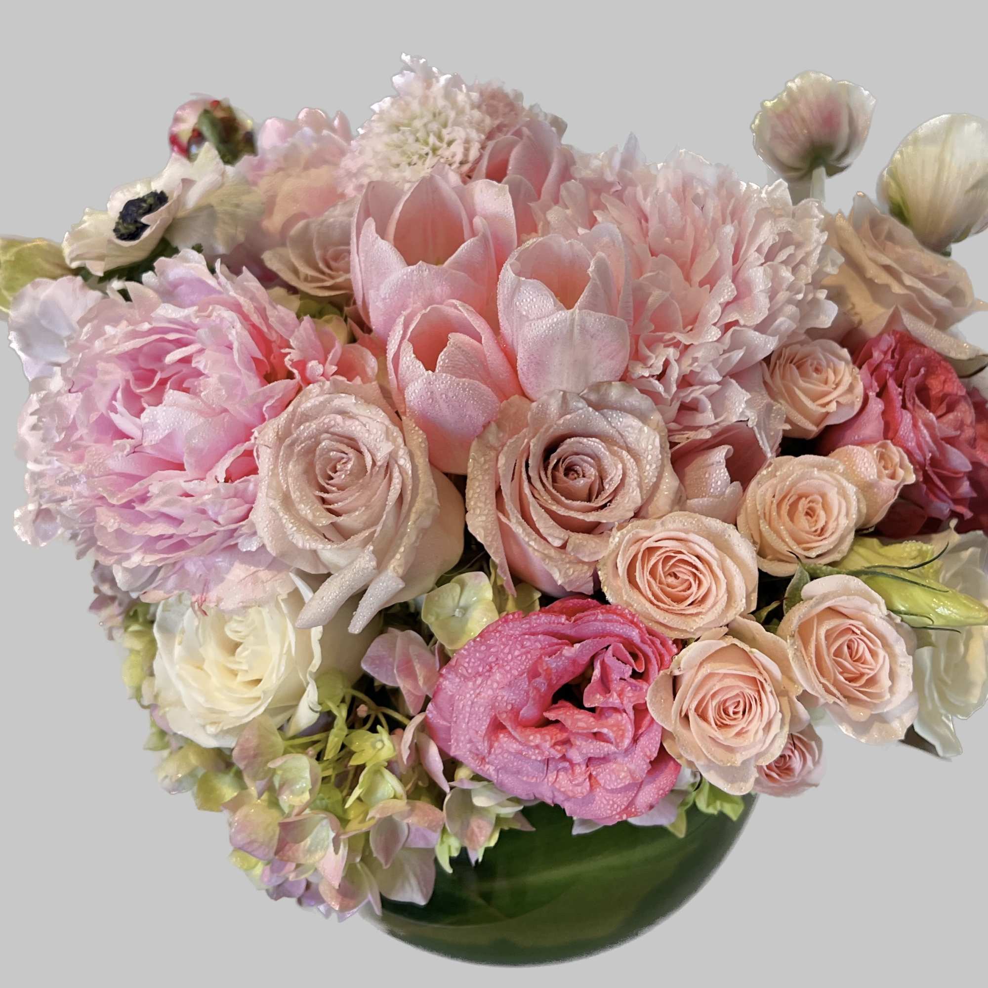 Pink and cream bouquet in a green vase