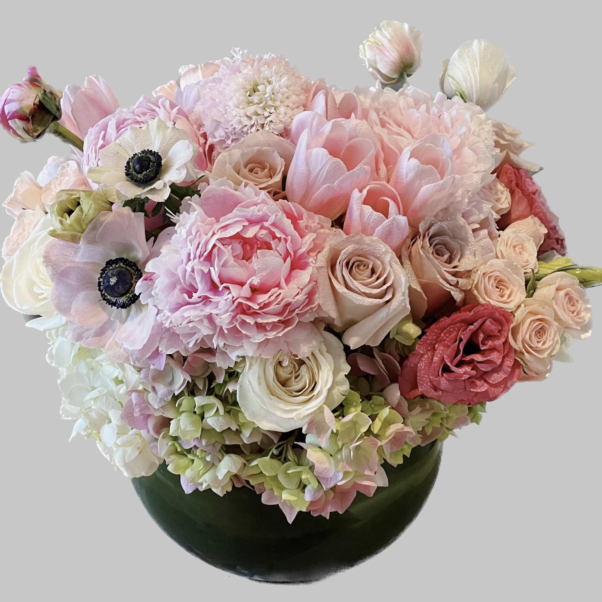 Pink and white bouquet in a dark green vase