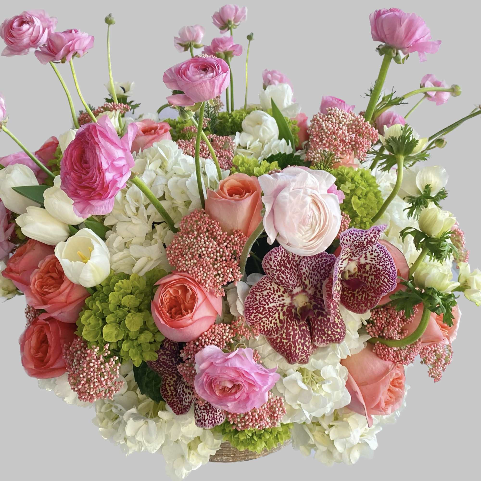 Pink and white mixed flower arrangement in a basket