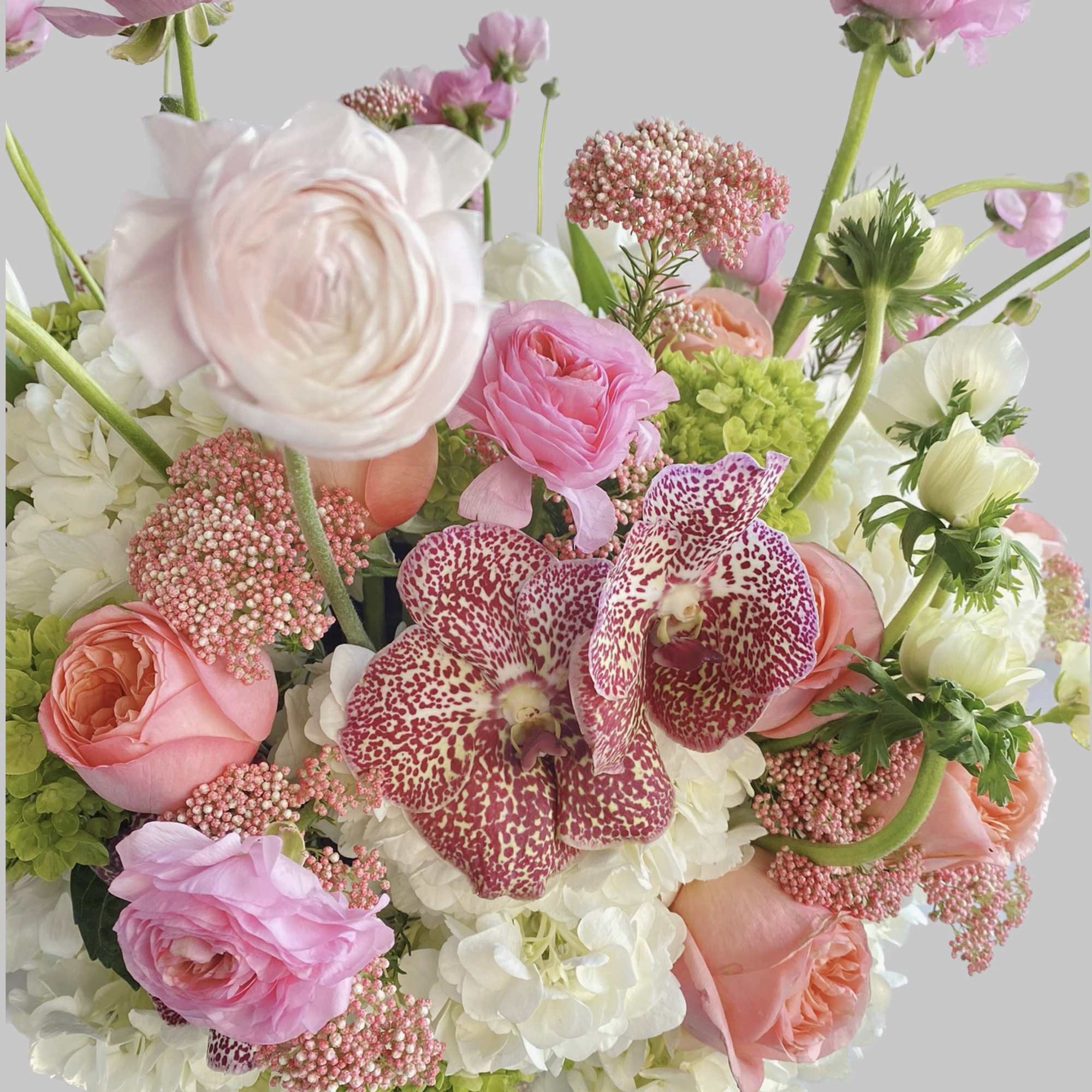 Pink and white bouquet with orchids and roses