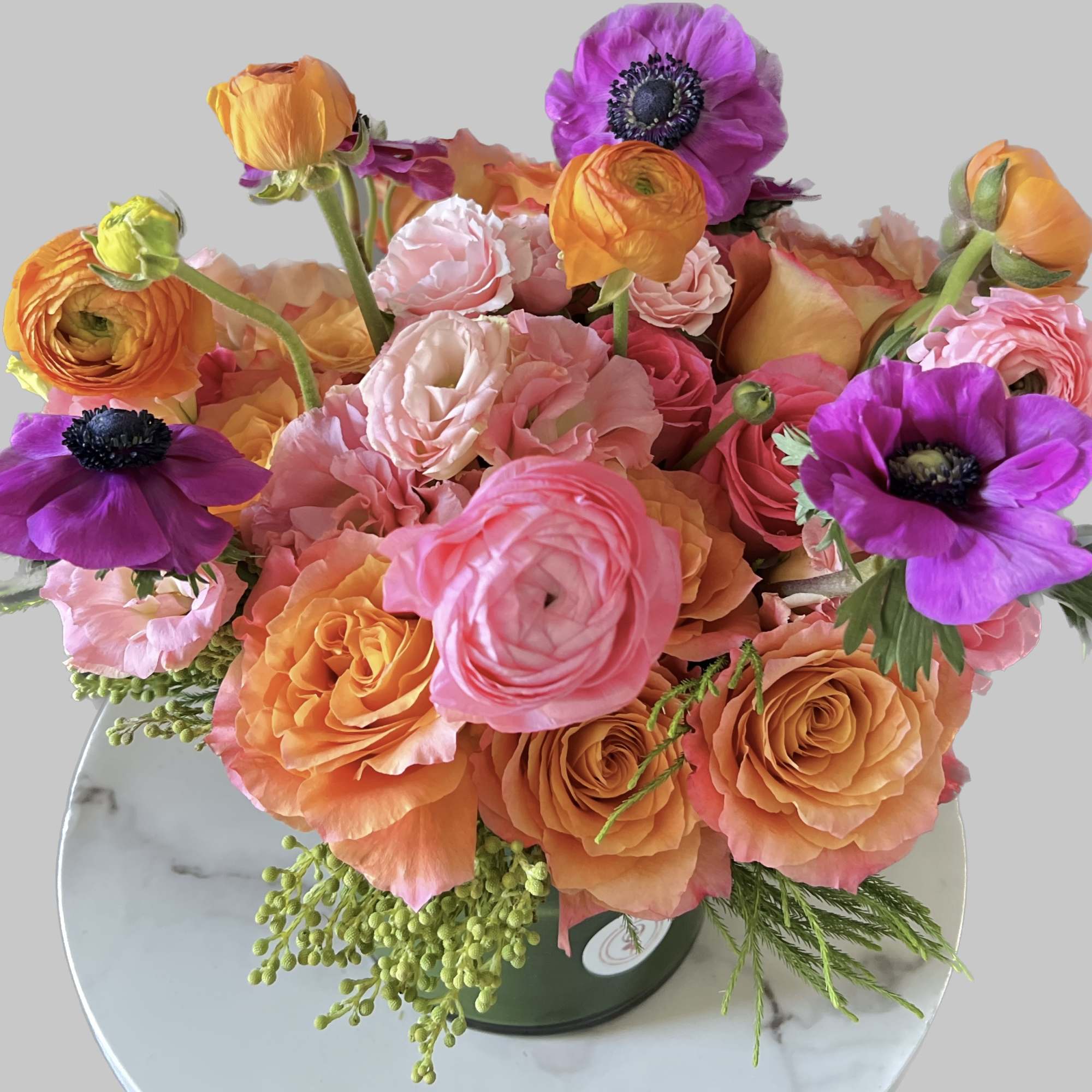 Bouquet of pink, orange, and purple flowers in a vase