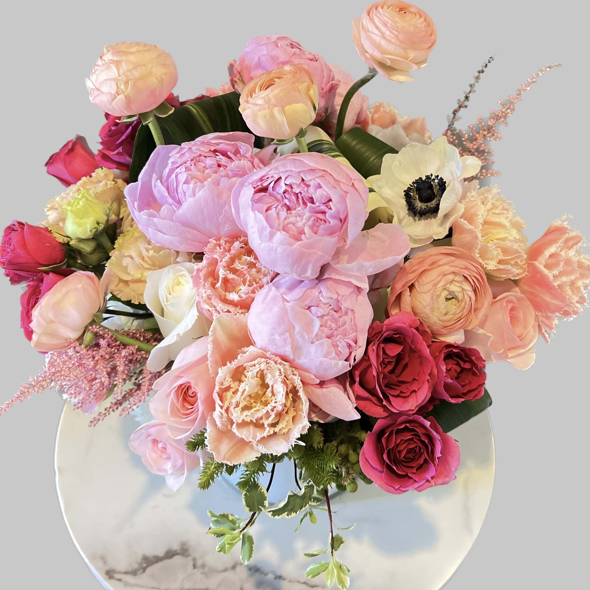 Pink and peach mixed bouquet with roses and peonies in a vase