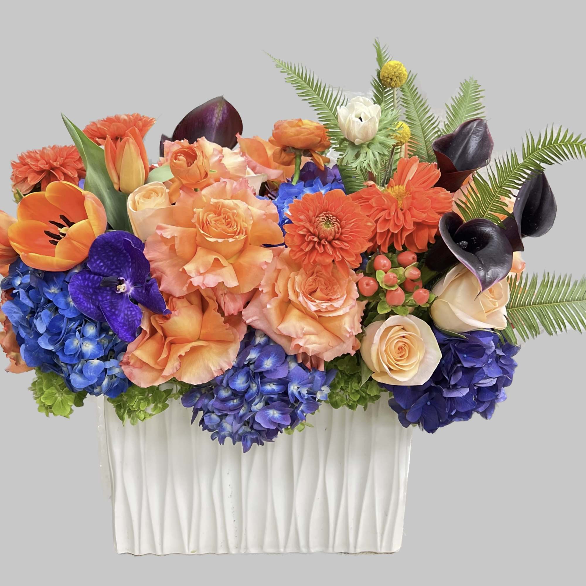 Colorful floral arrangement in a white rectangular vase, photo 2 of 2