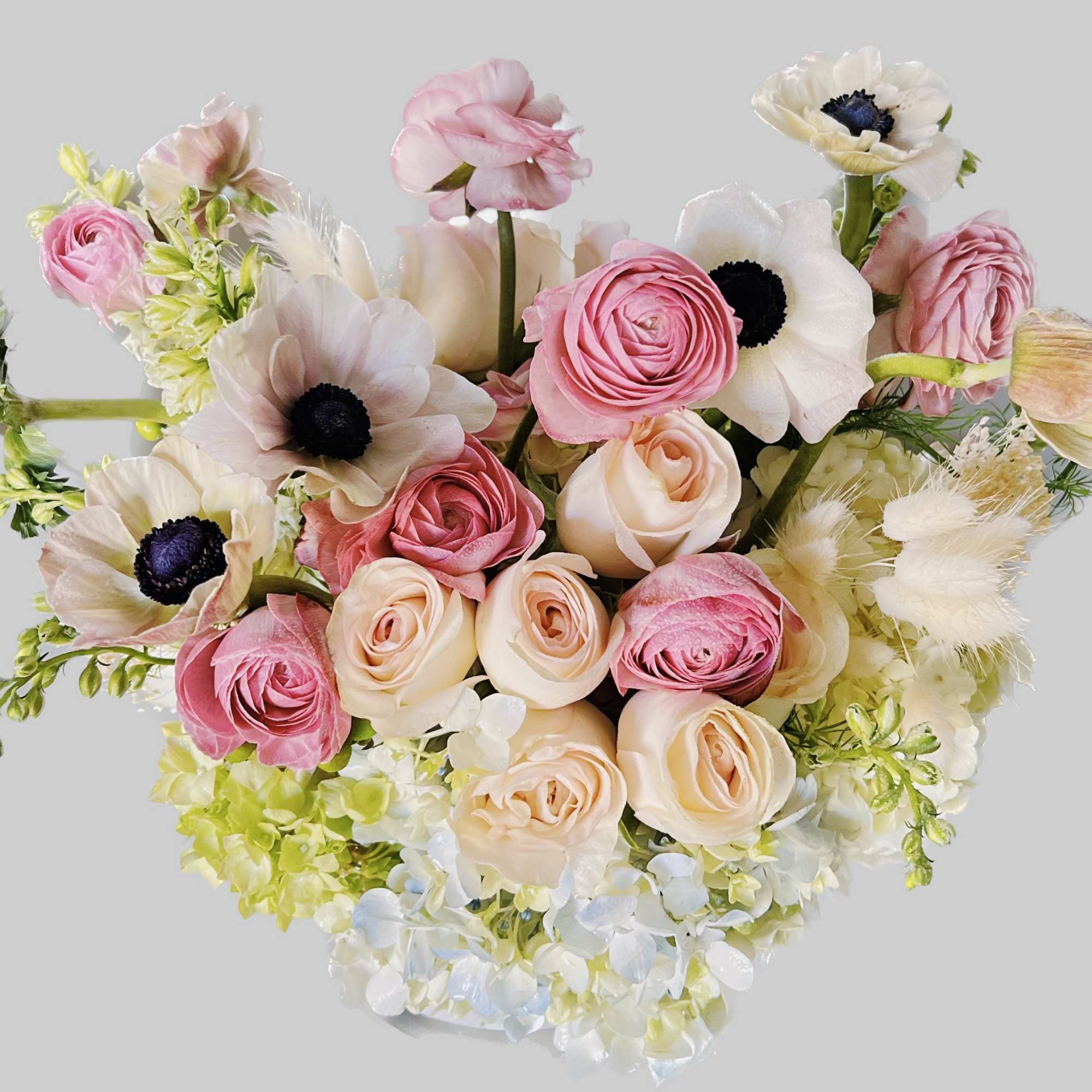 Bouquet of pink and cream flowers with white anemones